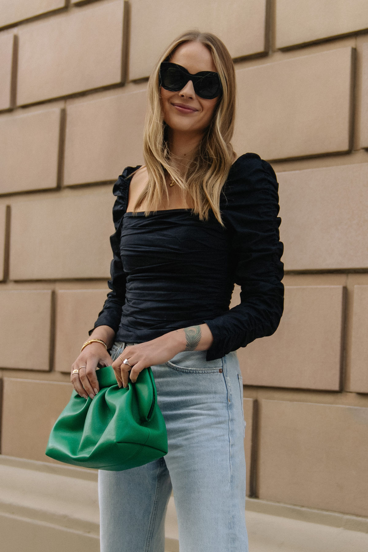 Fashion Jackson Wearing Black Rouched Reformation Top Green Clutch Light Wash Jeans