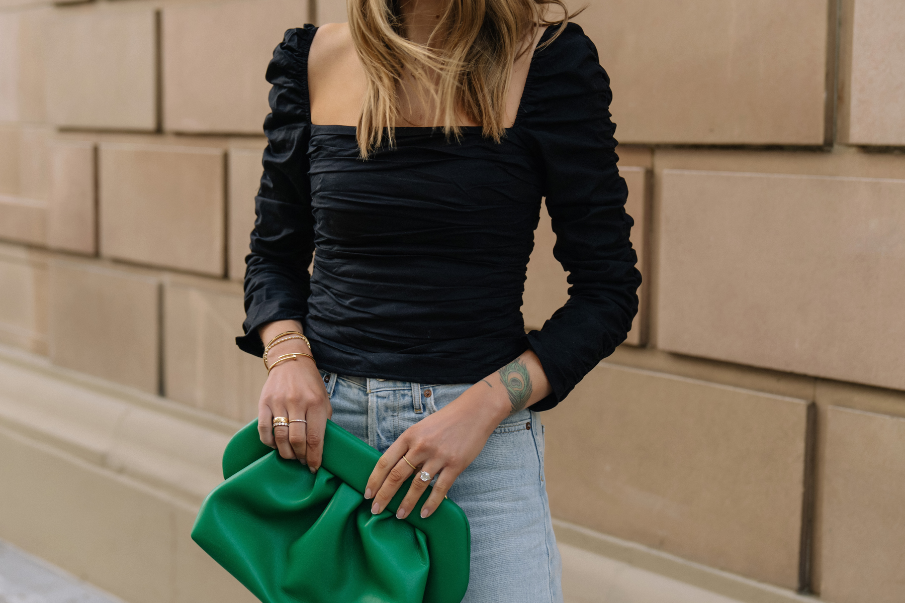 Fashion Jackson Wearing Black Rouched Reformation Top Green Clutch Light Wash Jeans