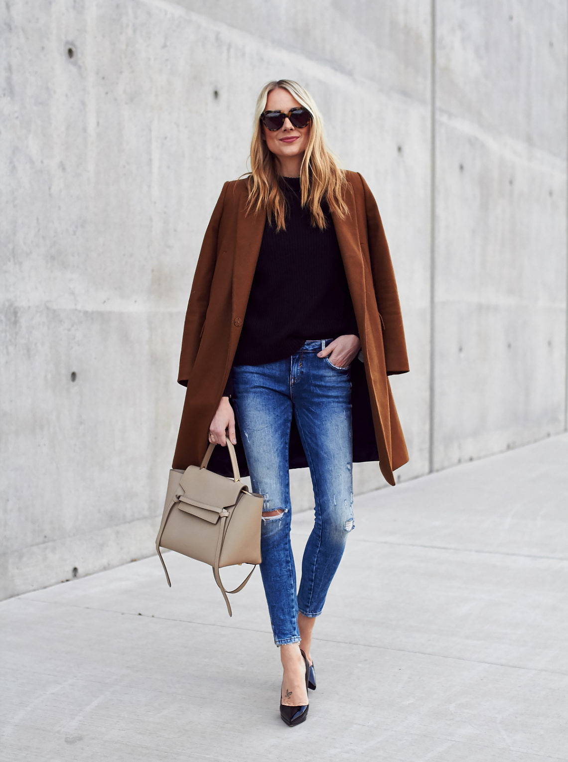 Fall Outfit, Winter Outfit, Tan Topcoat, Black Sweater, Denim Ripped Skinny Jeans, Celine Tie Belt Bag, Black Louboutin Pumps
