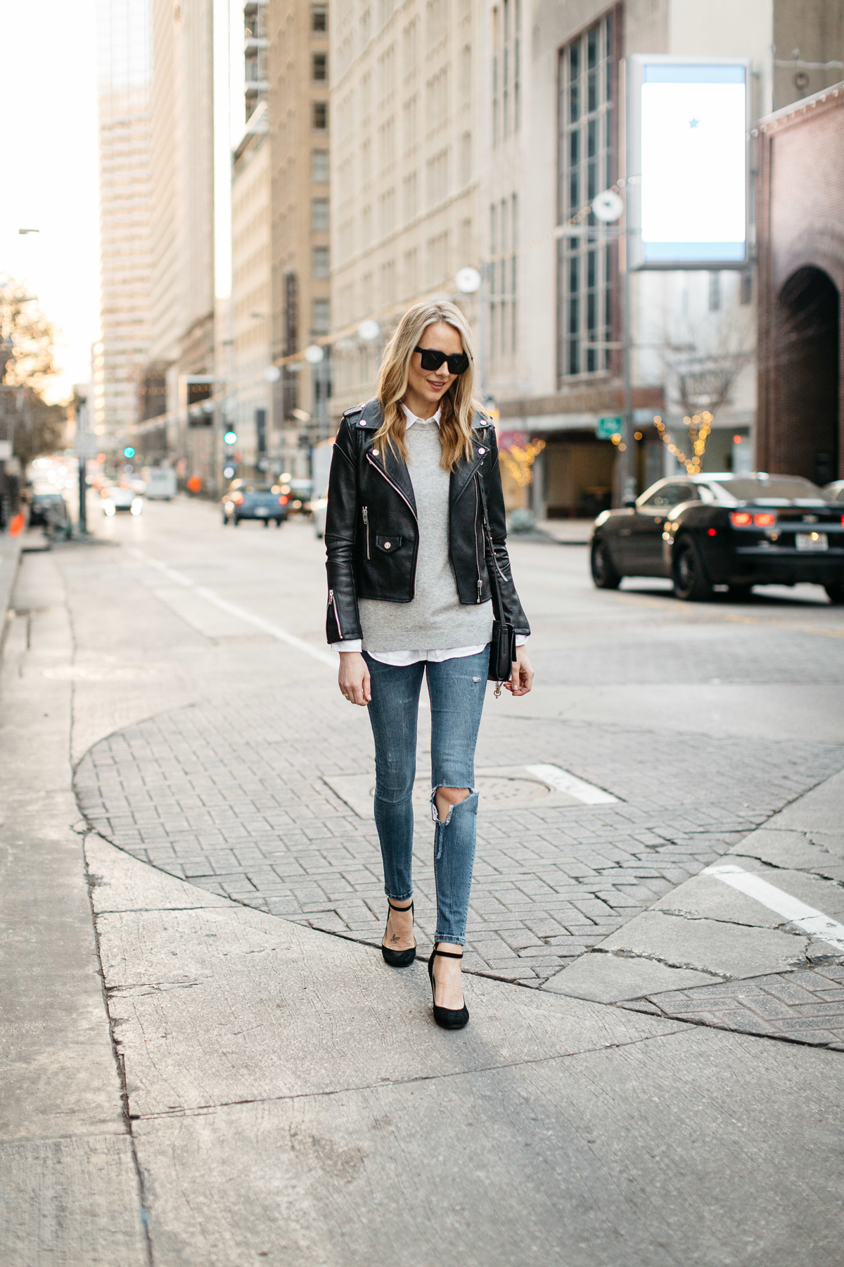 Fall Outfit, Winter Outfit, Black Leather Jacket, Grey Sweater, White Button-Down Shirt, Denim Ripped Skinny Jeans, Black Ankle Strap Pumps