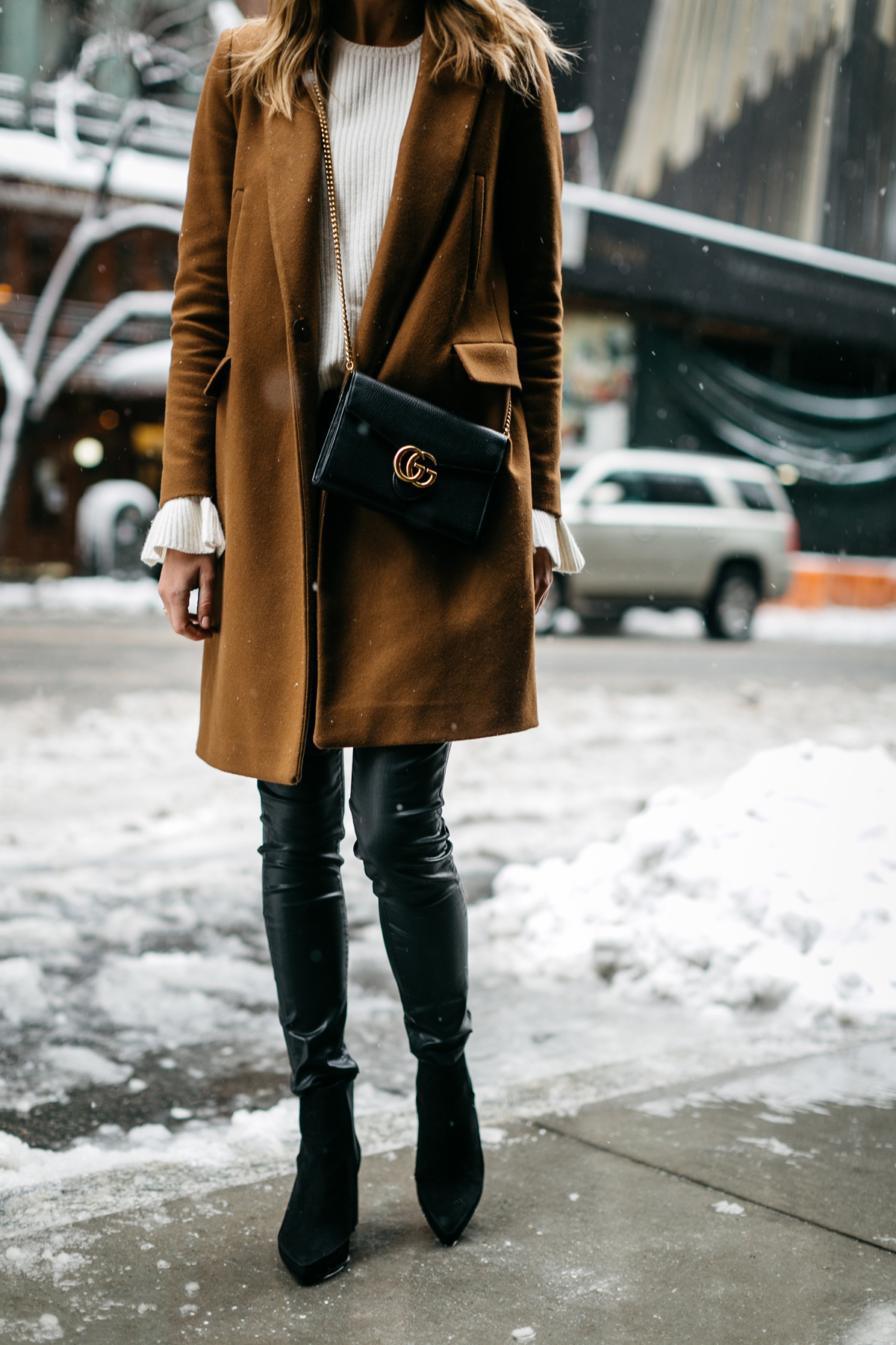 NYFW, Winter Outfit, Camel Wool Coat, White Ruffle Sleeve Sweater, Black Faux Leather Pants, Black Booties, Gucci Marmont Handbag, Street Style