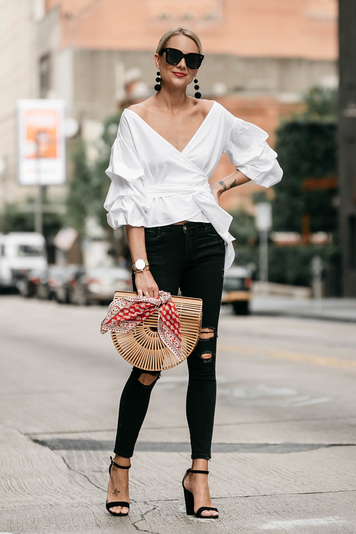 Blonde Woman Wearing Club Monaco Ruffle Sleeve Wrap Top Cult Gaia Ark Bag Red Bandana Black Ripped Skinny Jeans Street Style Outfit