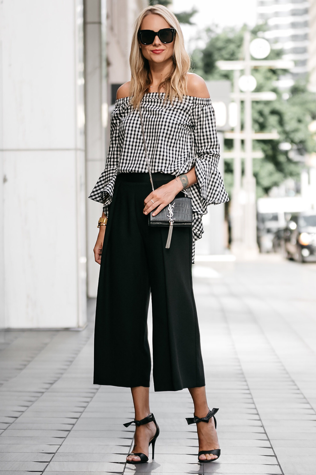 Blonde woman wearing nordstrom gingham off-the-shoulder top topshop black culottes outfit black bow heels ysl crossbody street style dallas blogger fashion blogger