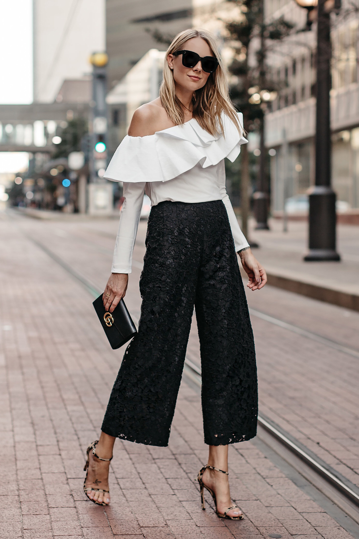 Black lace top + culotte pants date night outfit by extra petite