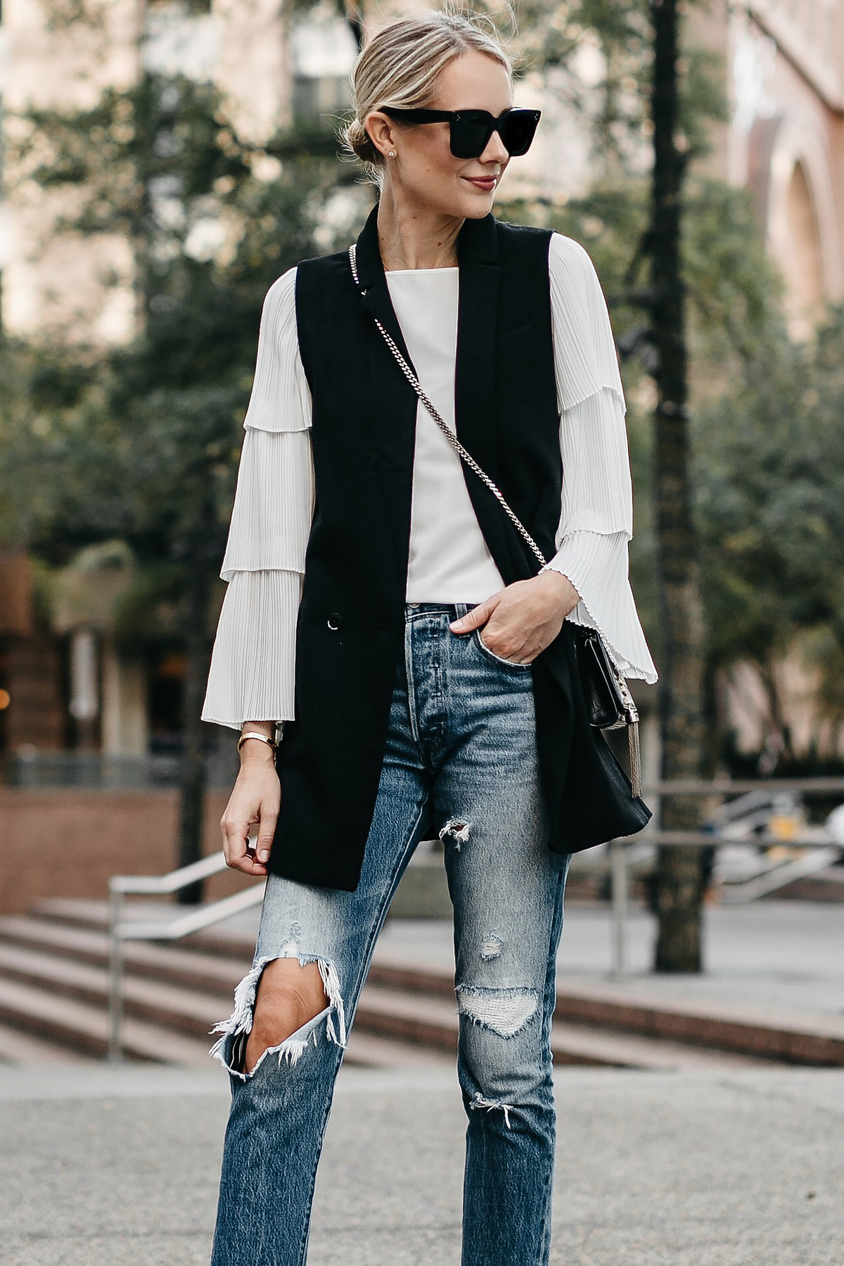 Blonde Woman Wearing Long Black Vest White Pleat Sleeve Top Denim Ripped Jeans Fashion Jackson Dallas Blogger Fashion Blogger Street Style