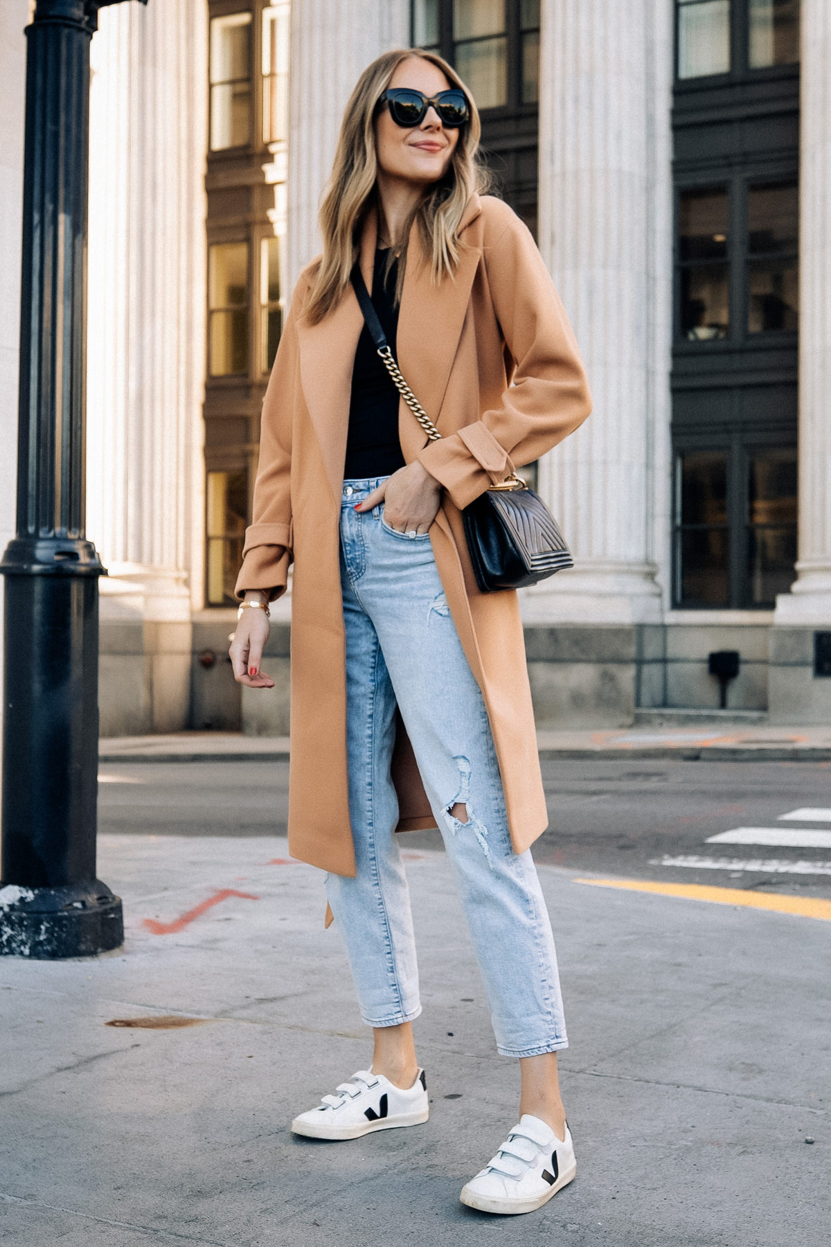 Fashion Jackson Wearing Express Camel Coat Black Tee Ripped Jeans Veja Sneakers Black Handbag Street Style Fall Outfit 1