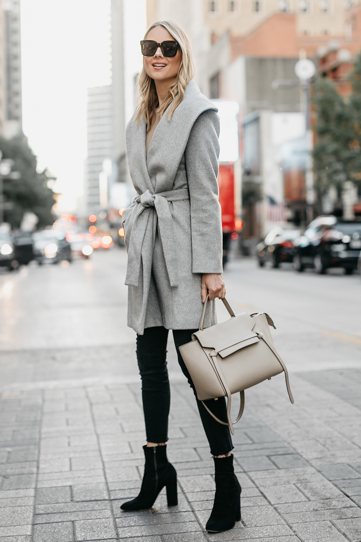 Blonde Woman Wearing Grey Wrap Coat Black Skinny Jeans Black Booties Outfit Celine Mini Belt Bag Fashion Jackson Dallas Blogger Fashion Blogger Street Style