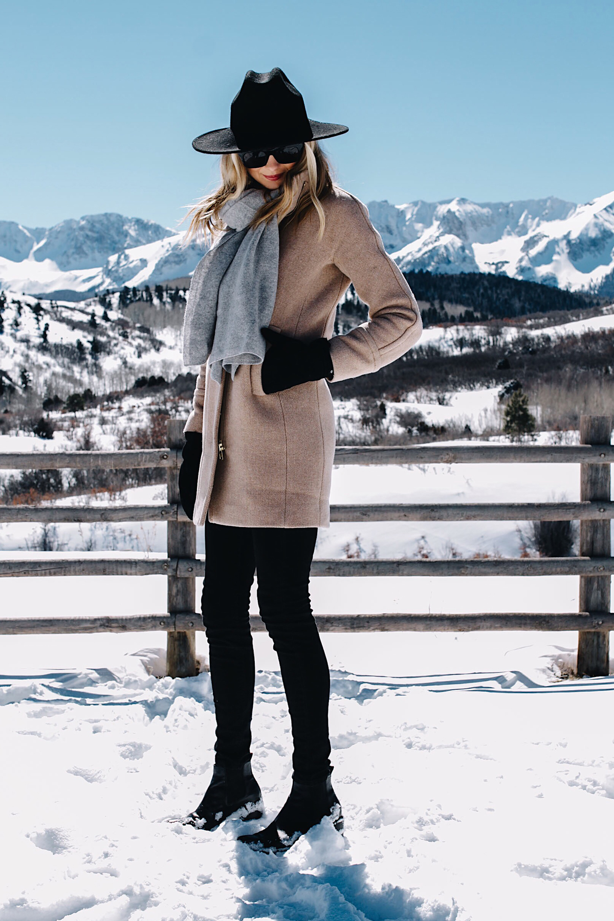 Telluride CO Snow Mountains Blonde Woman Wearing Grey Scarf Camel Coat Black Skinny Jeans Black Wool Hat Black Gloves Fashion Jackson Dallas Blogger Fashion Blogger