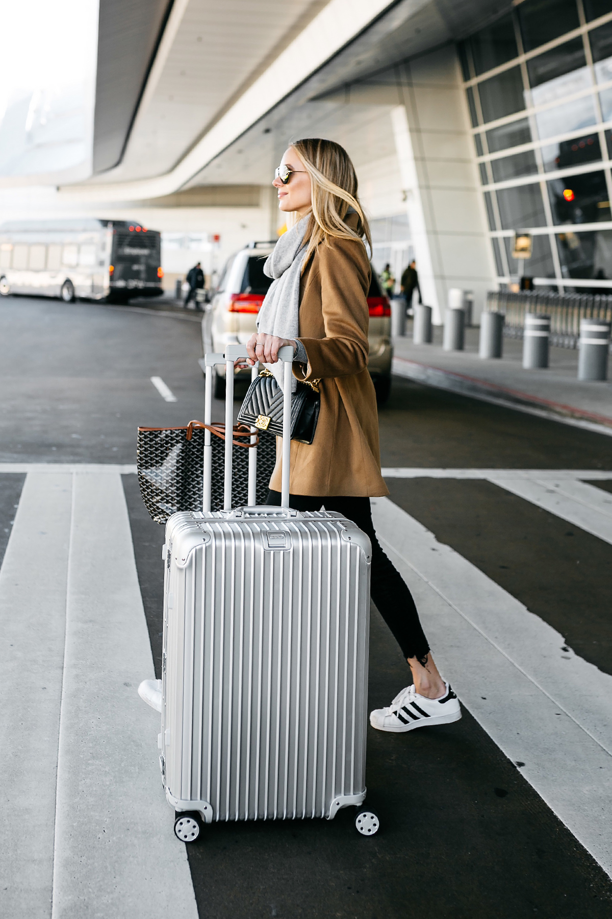 Blonde Woman Wearing Camel Coat Black Ripped Skinny Jeans Grey Scarf Chanel Black Boy Bag adidas Superstar Sneakers Rimowa Luggage Fashion Jackson Dallas Blogger Fashion Blogger Street Style Airport Style