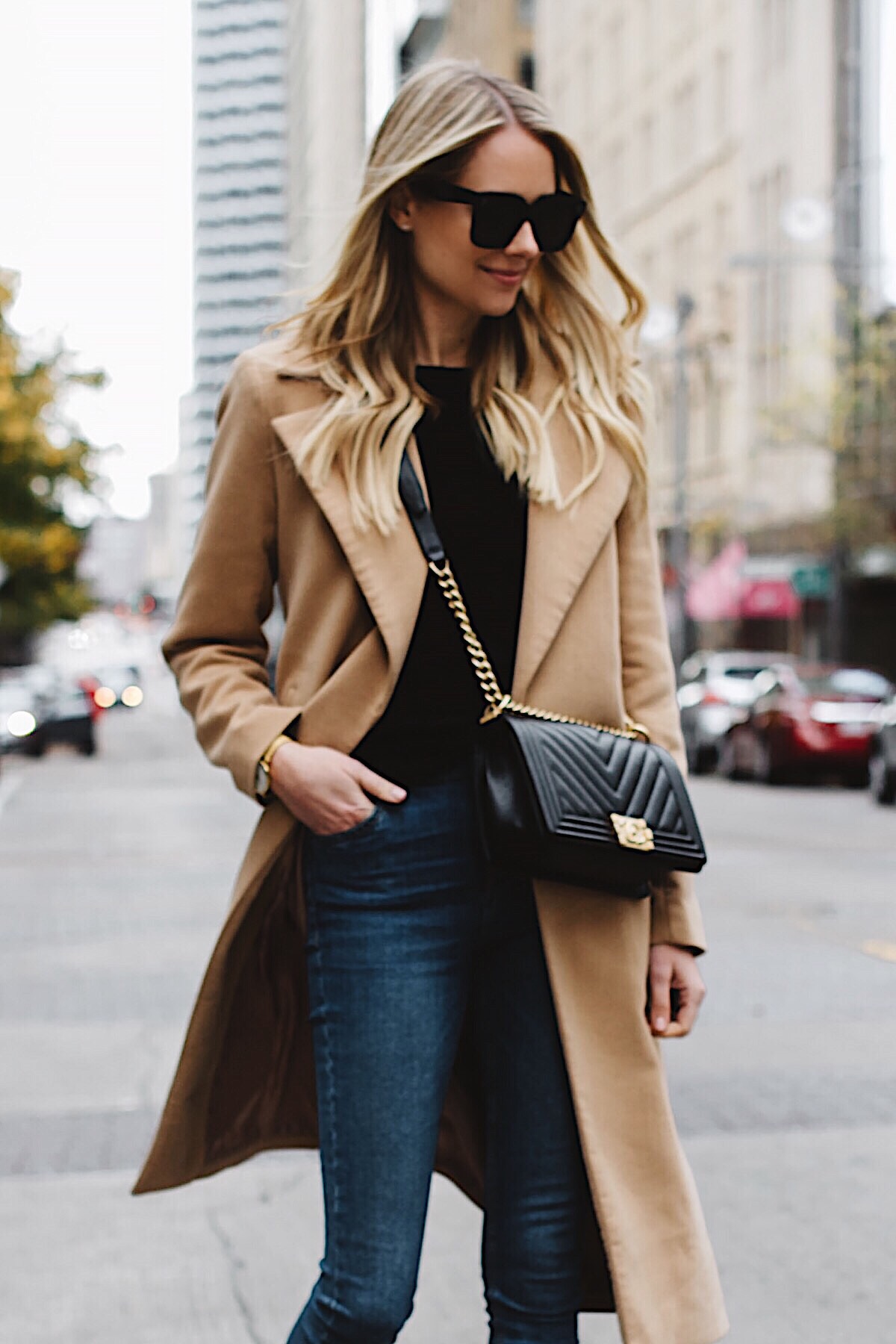 blonde woman wearing long camel coat black sweater topshop denim skinny jeans chanel black boy bag fashion jackson dallas blogger fashion blogger street style