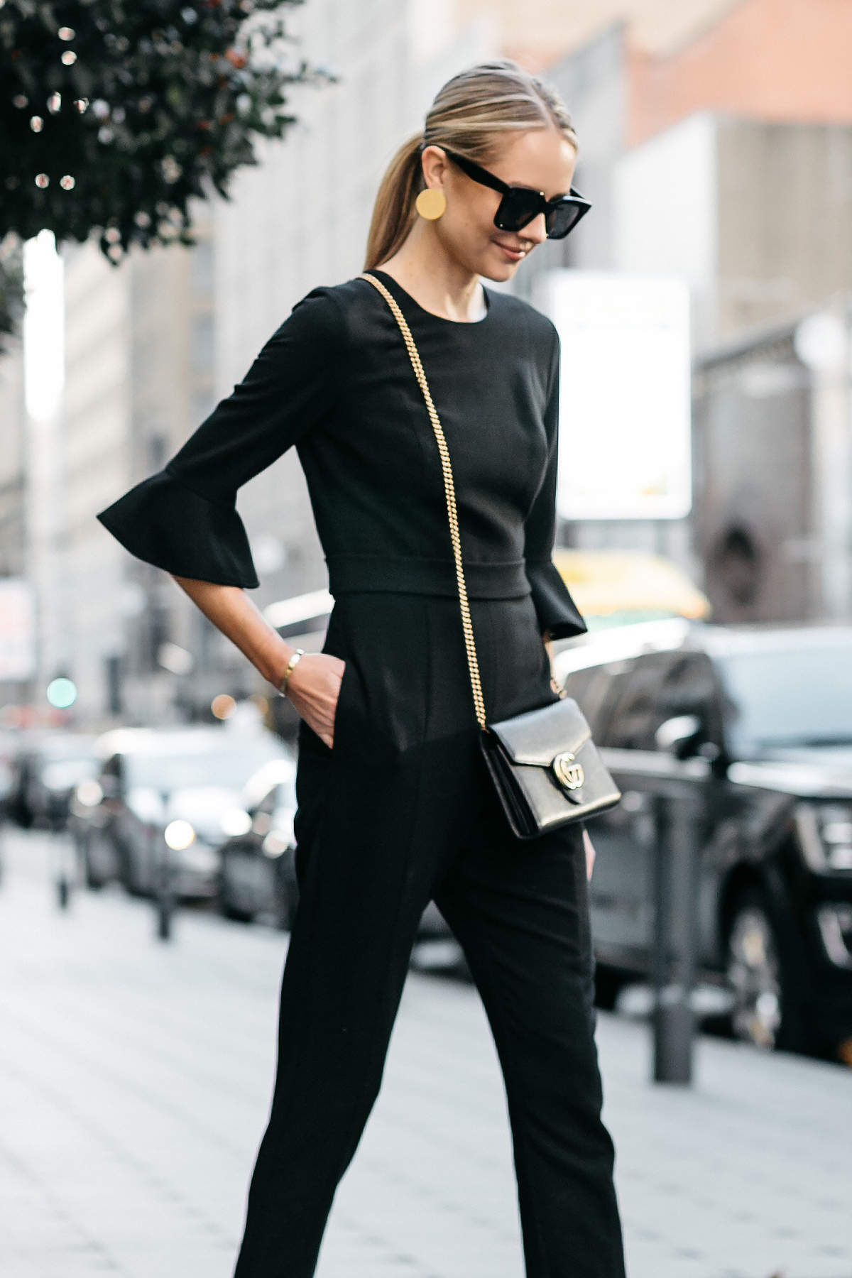 Blonde Woman Wearing Gucci Marmont Wallet Handbag Black Ruffle Sleeve Jumpsuit Gold Disc Earrings Black Celine Sunglasses Fashion Jackson Dallas Blogger Fashion Blogger Street Style