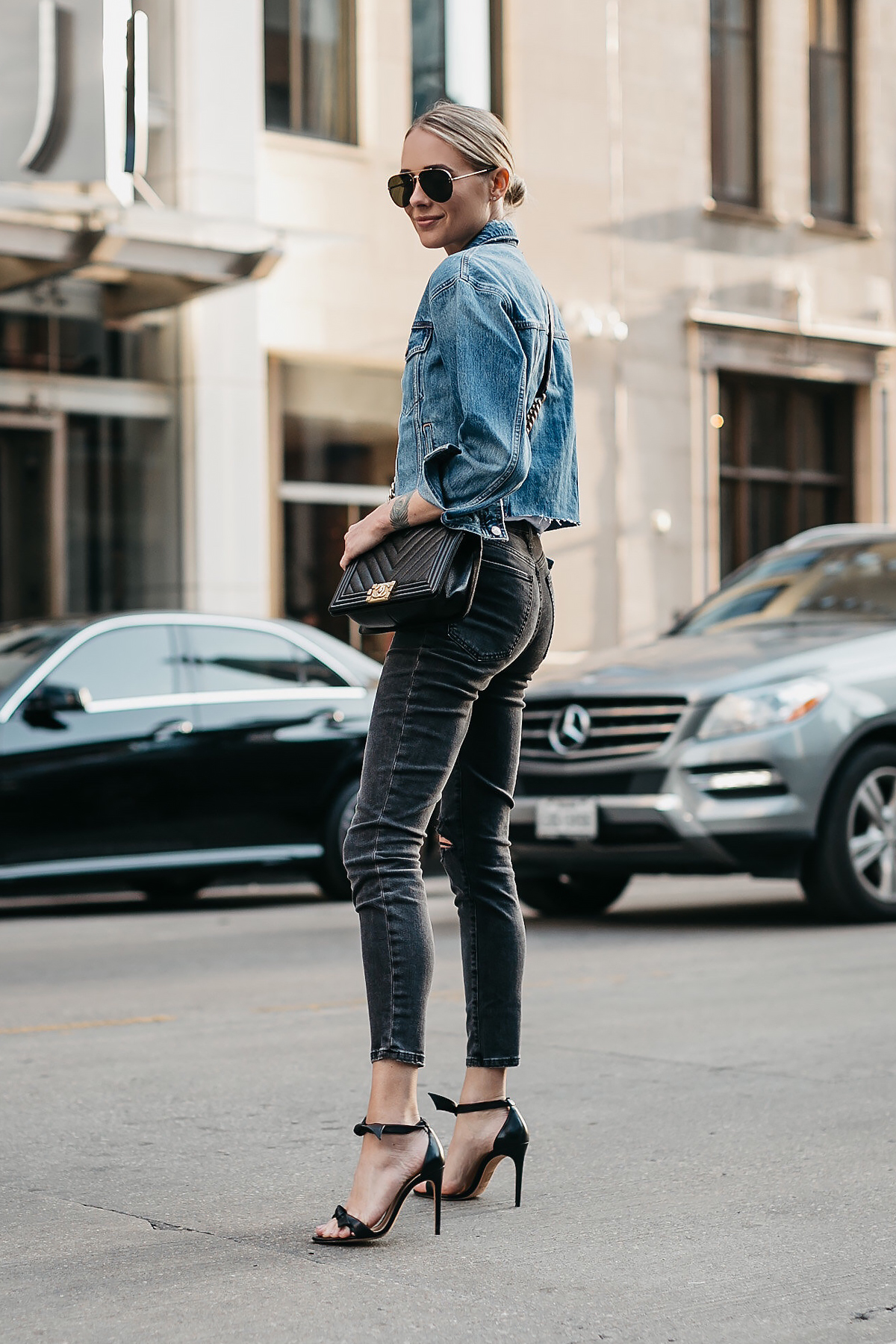 Blonde Woman Wearing Joes Jeans Black Ripped Skinny Jeans Denim Jacket Chanel Black Boy Bag Alexandre Birman Black Bow Heels Celine Aviator Sunglasses Fashion Jackson Dallas Blogger Fashion Blogger Street Style