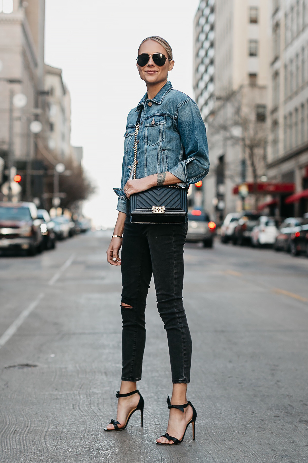 Blonde Woman Wearing Joes Jeans Black Ripped Skinny Jeans Denim Jacket Chanel Black Boy Bag Alexandre Birman Black Bow Heels Celine Aviator Sunglasses Fashion Jackson Dallas Blogger Fashion Blogger Street Style