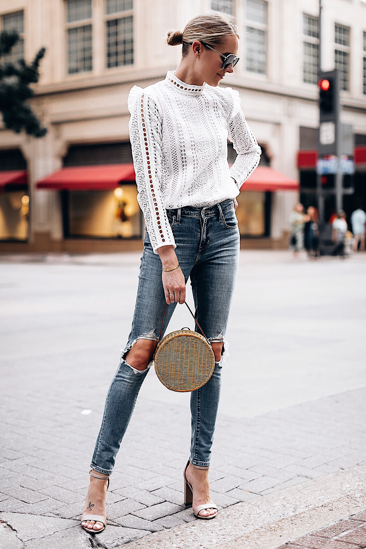 Blonde Woman Wearing Fashion Jackson Bloomingdales AQUA White Lace Ruffle Top Levis 721 Skinny Jeans Tan Ankle Strap Heeled Sandals Serpui Straw Circle Handbag Fashion Jackson San Diego Fashion Blogger Street Style