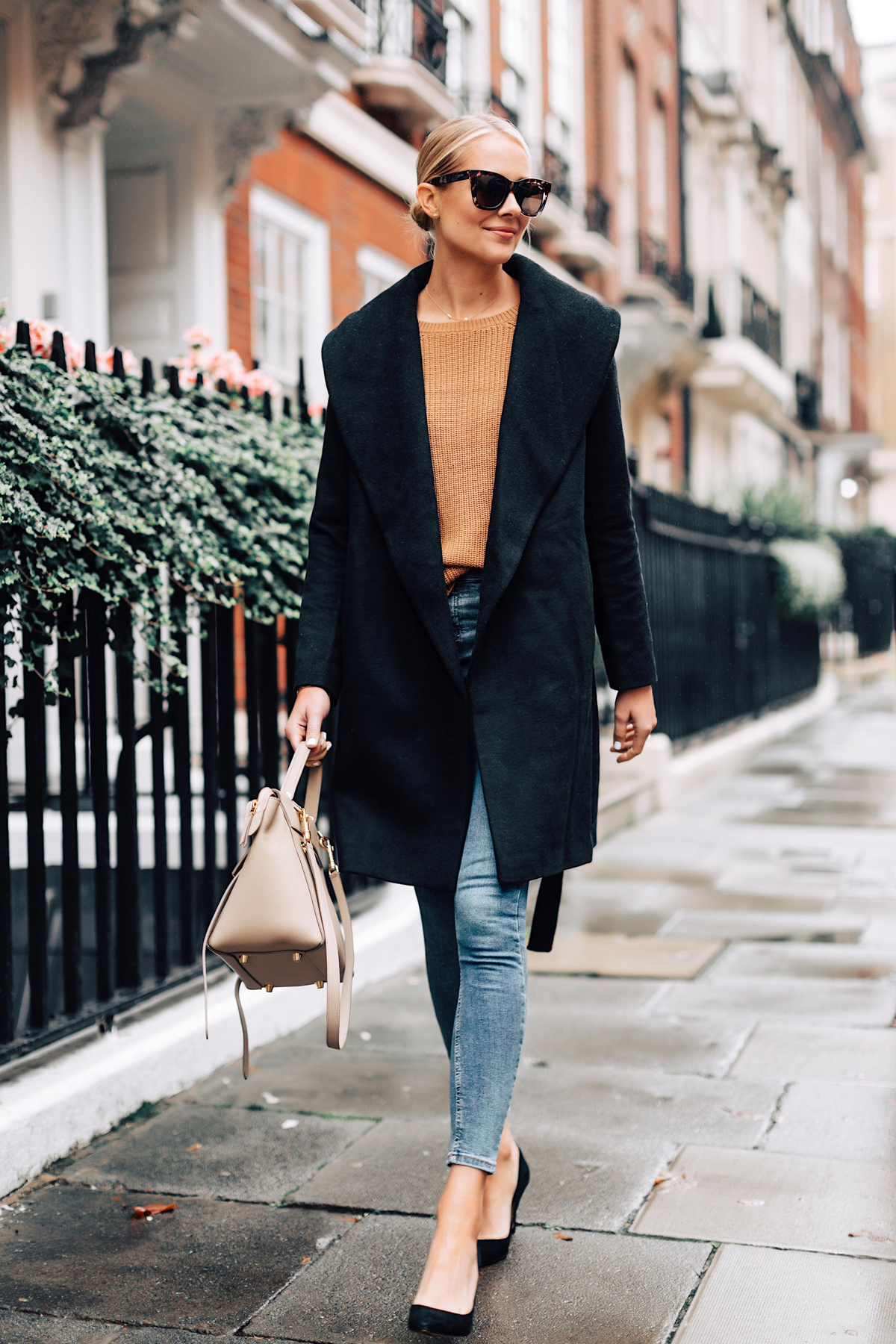 Chic layered fall outfit idea with camel sweater, black denim