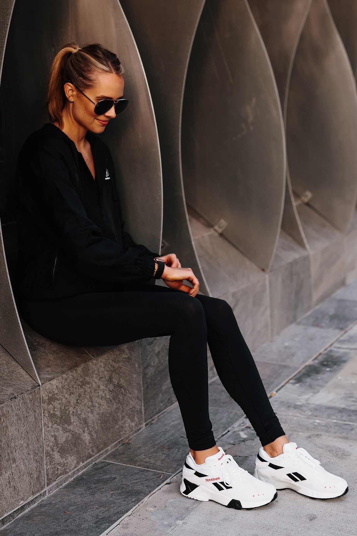 Blonde Woman Wearing Reebok Black Windbreaker Reebok Black Leggings Reebok Aztrek White Sneakers Fashion Jackson San Diego Fashion Blogger Activewear Street Style