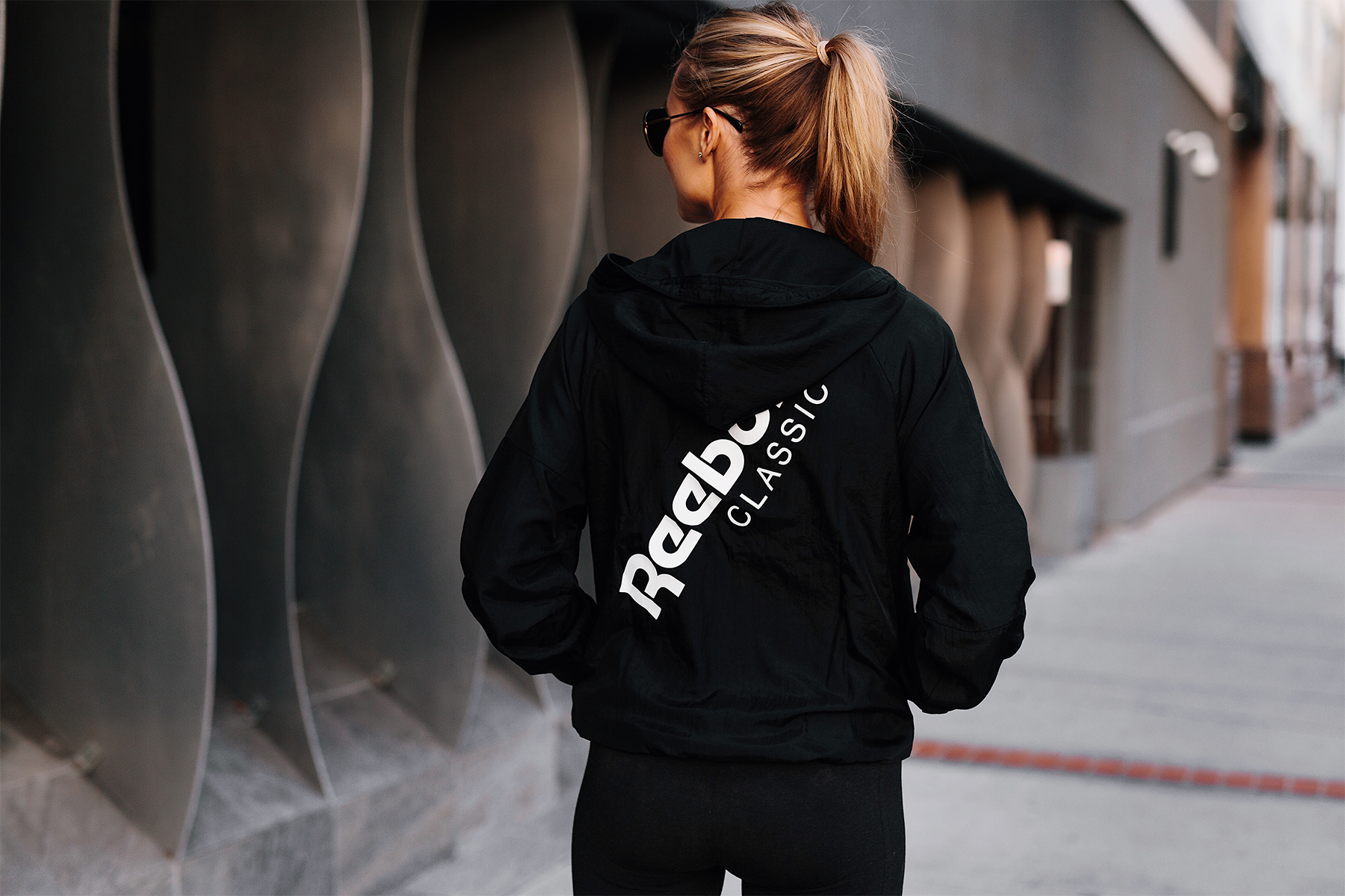 Blonde Woman Wearing Reebok Logo Black Windbreaker Fashion Jackson San Diego Fashion Blogger Activewear Street Style