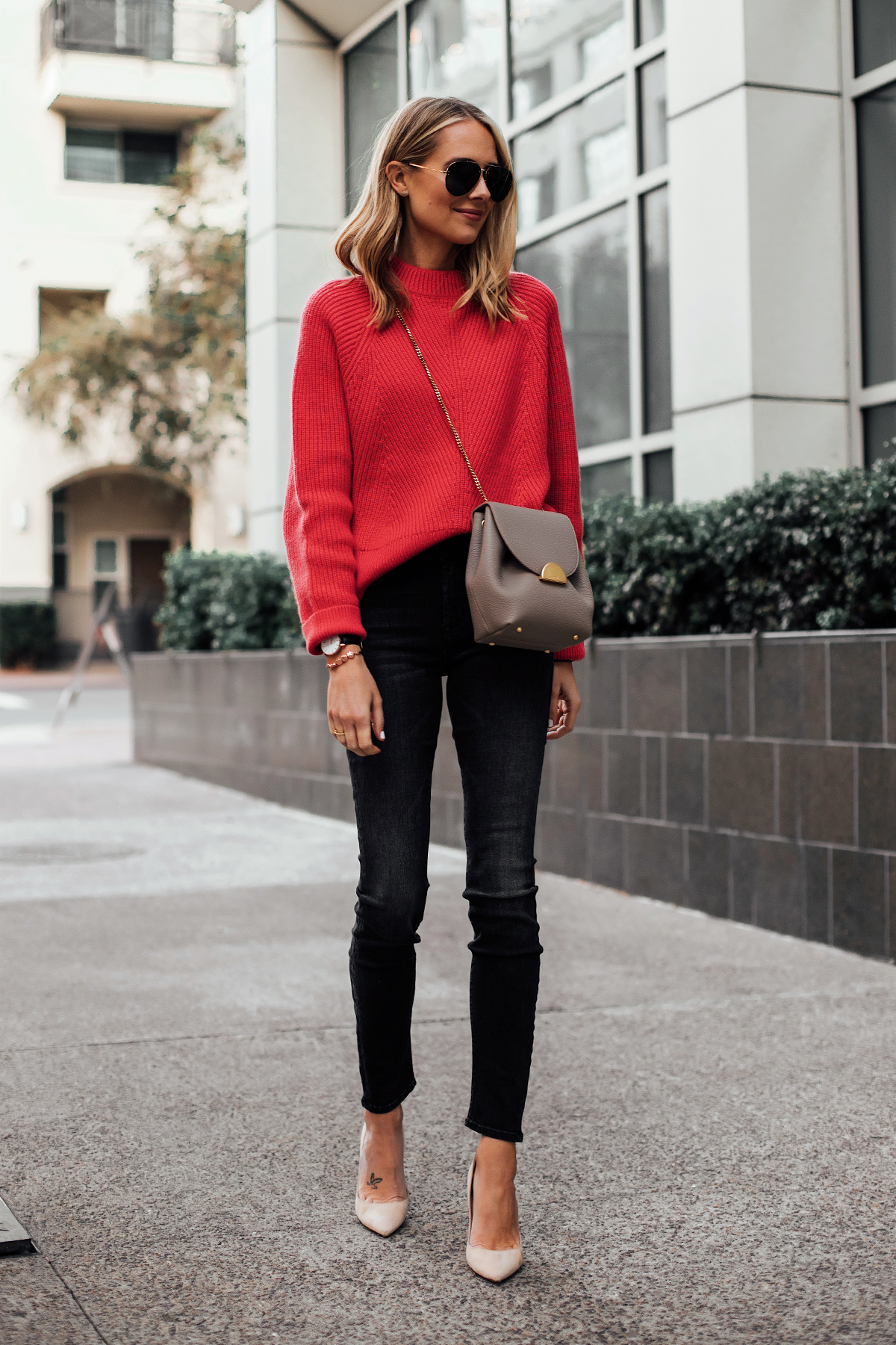 Woman Wearing AllSaints Red Sweater Polene Taupe Crossbody Handbag