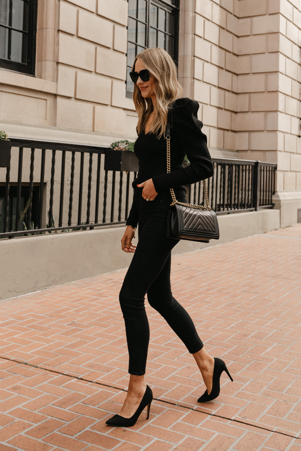 Fashion Jackson Wearing Black Puff Sleeve Sweater Black Skinny Jeans Black Pumps all black party outfits for women 2