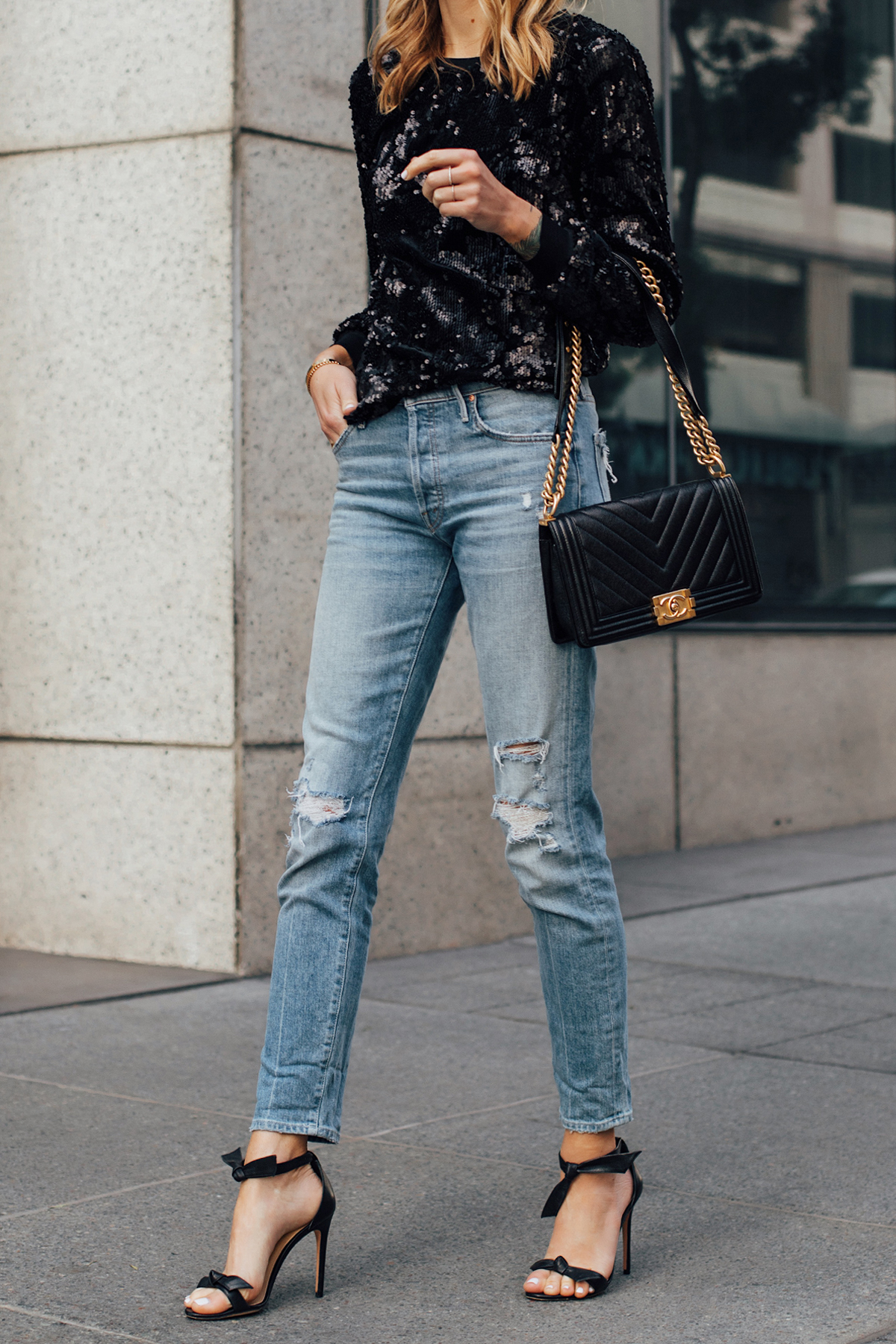 Blonde Woman Wearing Black Sequin Top Ripped Skinny Jeans Chanel Black Boy Bag Black Ankle Tie Heeled Sandals Fashion Jackson San Diego Fashion Blogger Street Style NYE Outfit