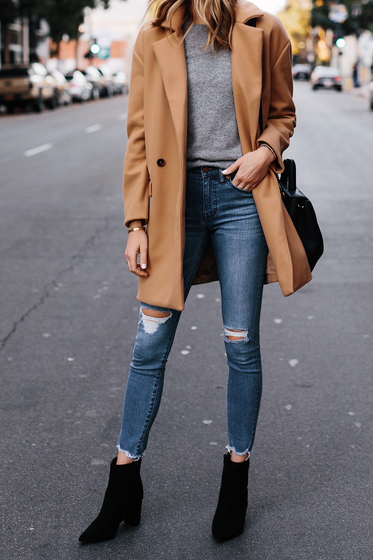 Woman Wearing Camel Coat Grey Sweater Denim Ripped Skinny Jeans Black Booties Outfit Fashion Jackson San Diego Fashion Blogger Street Style