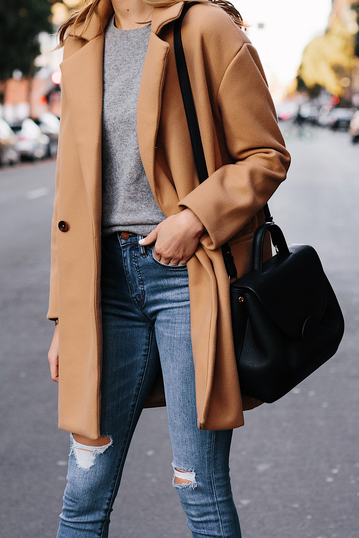 Woman Wearing Camel Coat Grey Sweater Denim Ripped Skinny Jeans Black Satchel Outfit Fashion Jackson San Diego Fashion Blogger Street Style