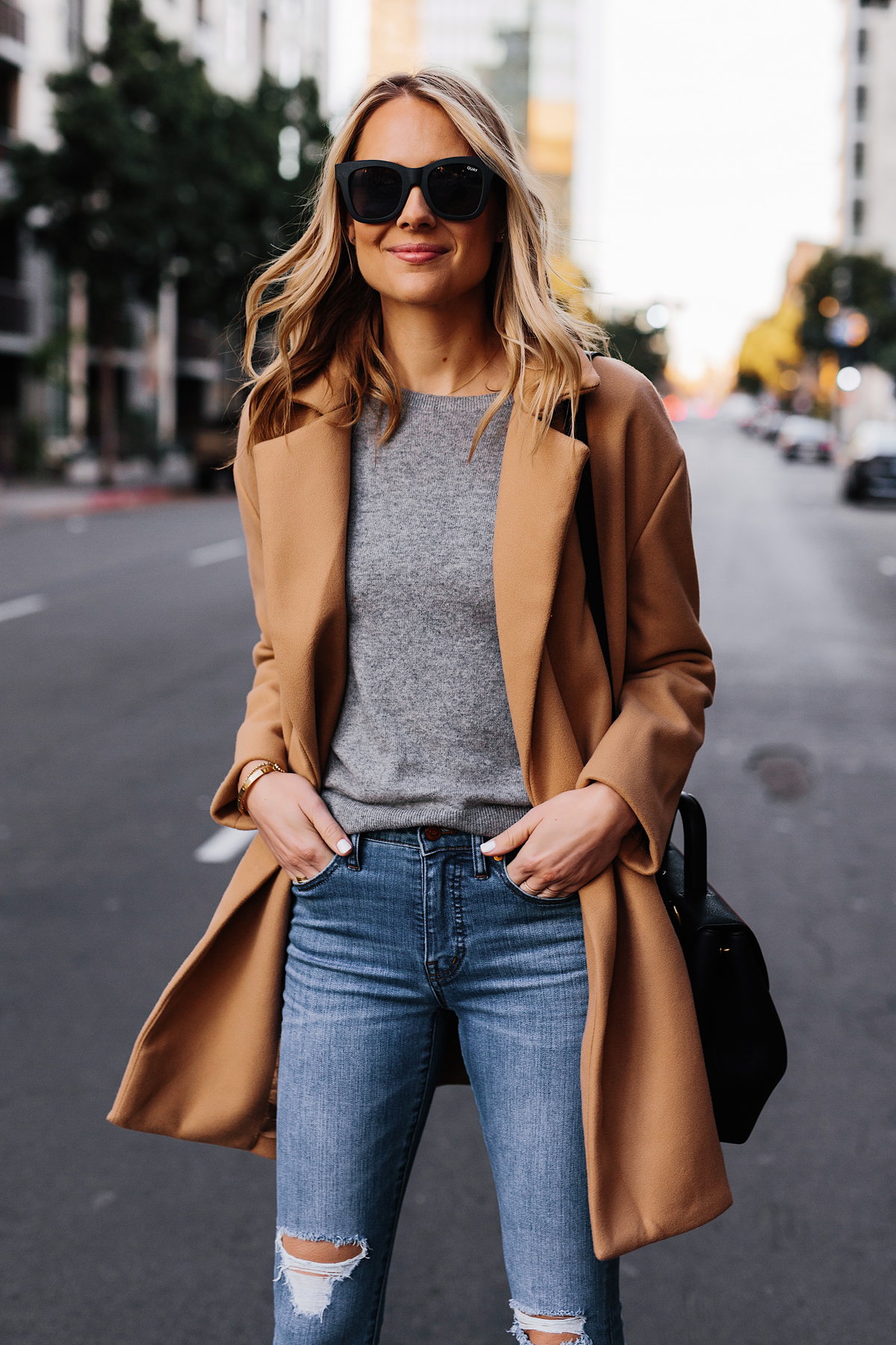 Blonde Woman Wearing Camel Coat Grey Sweater Denim Ripped Skinny Jeans Outfit Fashion Jackson San Diego Fashion Blogger Street Style