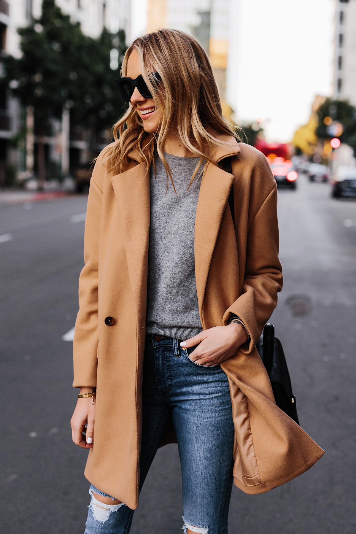 Blonde Woman Wearing Camel Coat Grey Sweater Denim Ripped Skinny Jeans Outfit Fashion Jackson San Diego Fashion Blogger Street Style