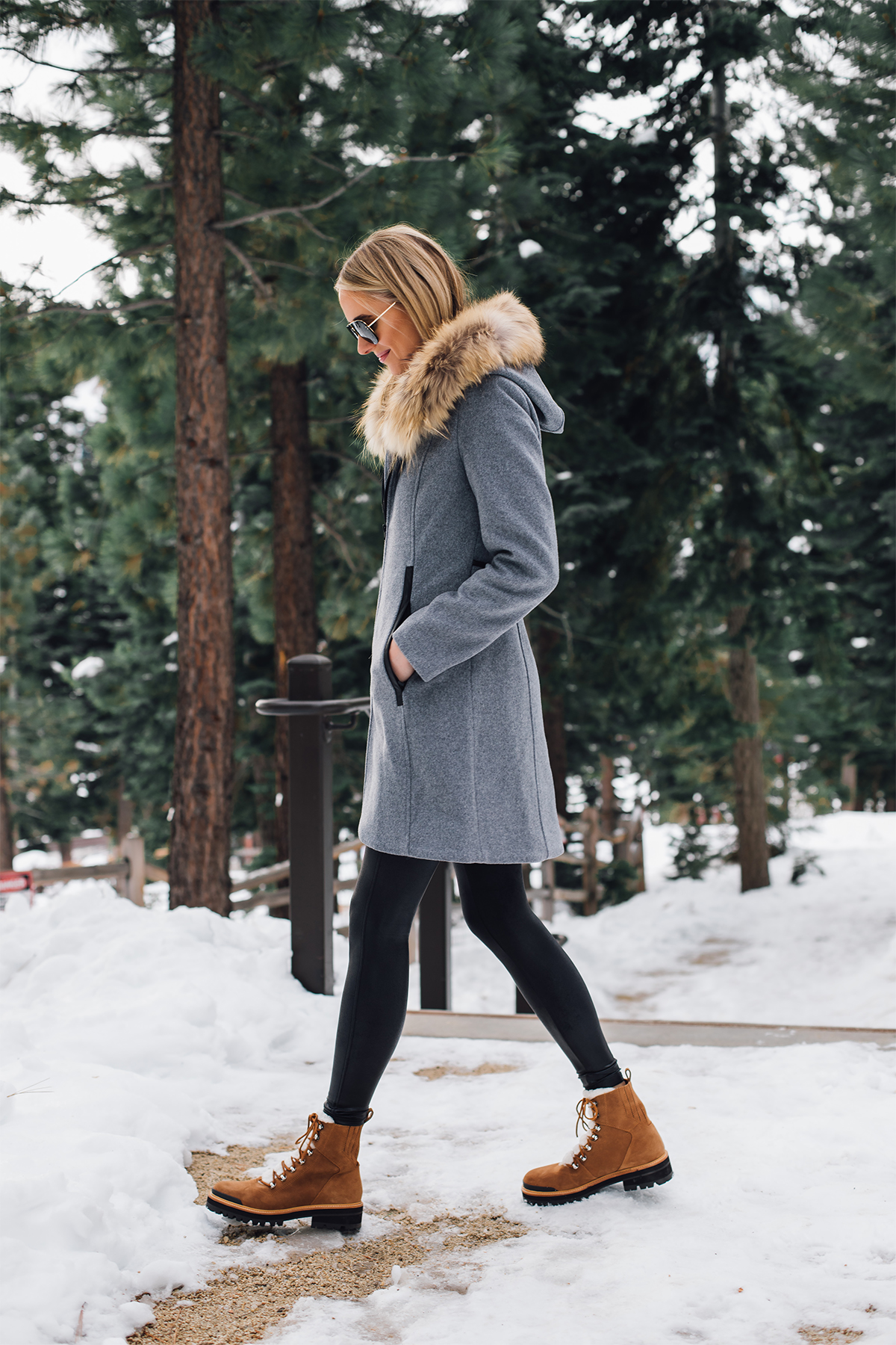 Blonde Woman Wearing Grey Wool Coat with Faux Fur Hood Spanx Black Faux Leather Leggings Brown Shearling Booties Outfit Fashion Jackson San Diego Fashion Blogger Lake Tahoe Winter Outfit