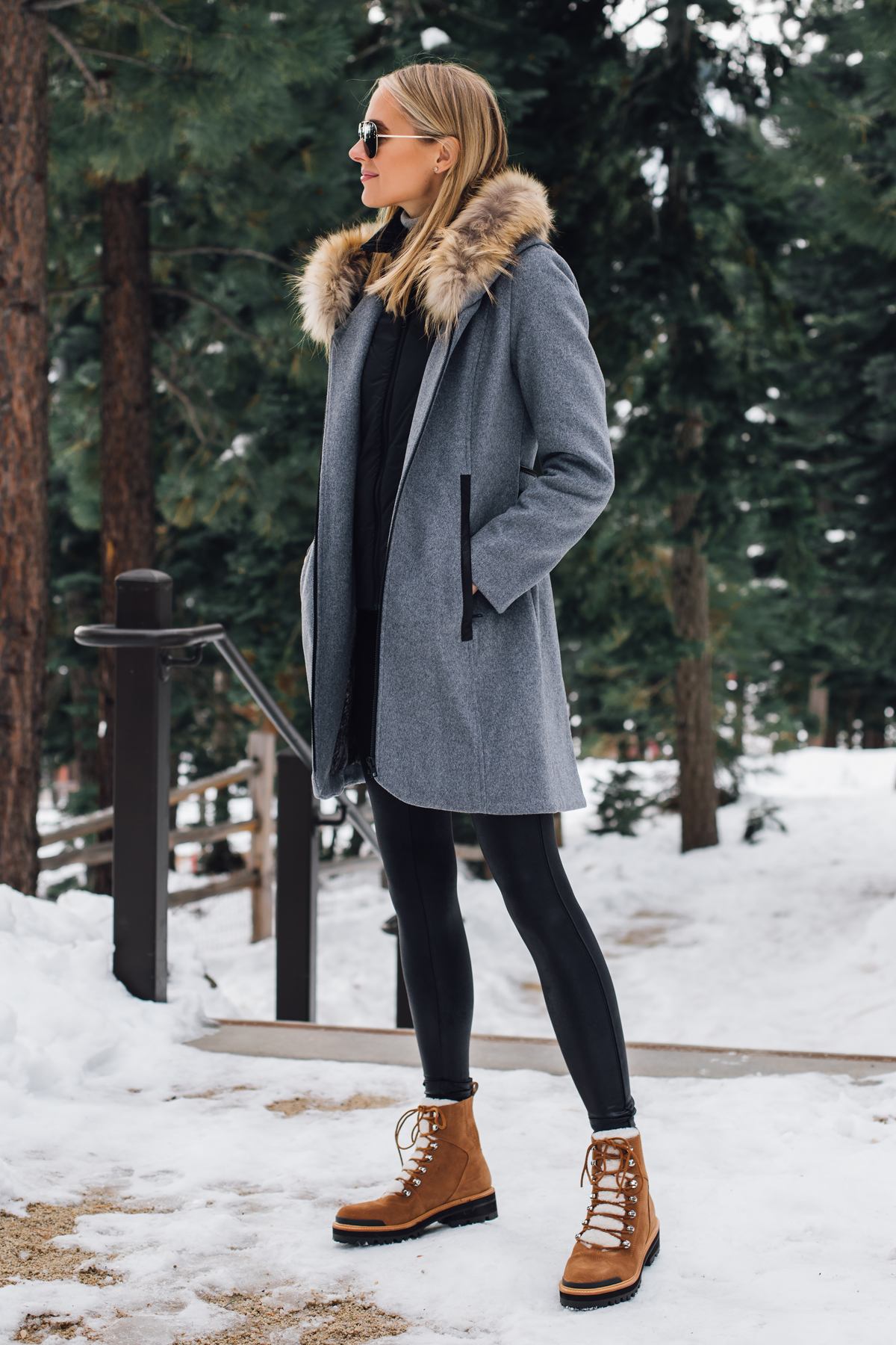 Blonde Woman Wearing Grey Wool Coat with Faux Fur Hood Spanx Black Faux Leather Leggings Brown Shearling Booties Outfit Fashion Jackson San Diego Fashion Blogger Lake Tahoe Winter Outfit