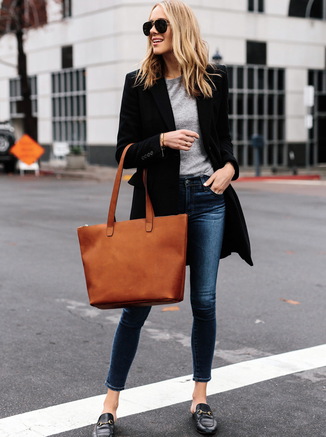Blonde Woman Wearing SLATE Cognac Tote Black Wool Coat Grey Sweater Denim Skinny Jeans Gucci Mules Outfit Fashion Jackson San Diego Fashion Blogger Street Style