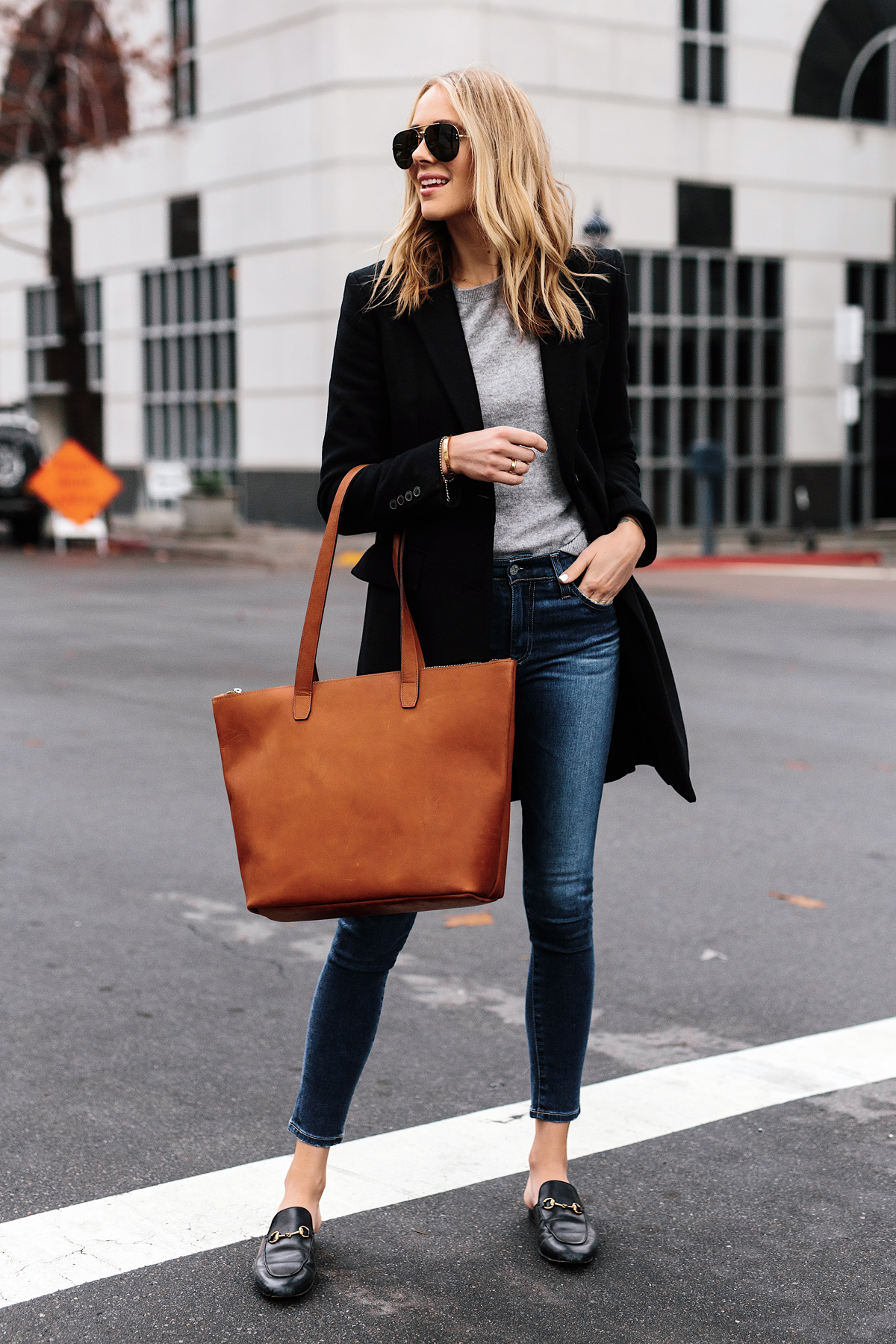 Blonde Woman Wearing SLATE Cognac Tote Black Wool Coat Grey Sweater Denim Skinny Jeans Gucci Mules Outfit Fashion Jackson San Diego Fashion Blogger Street Style