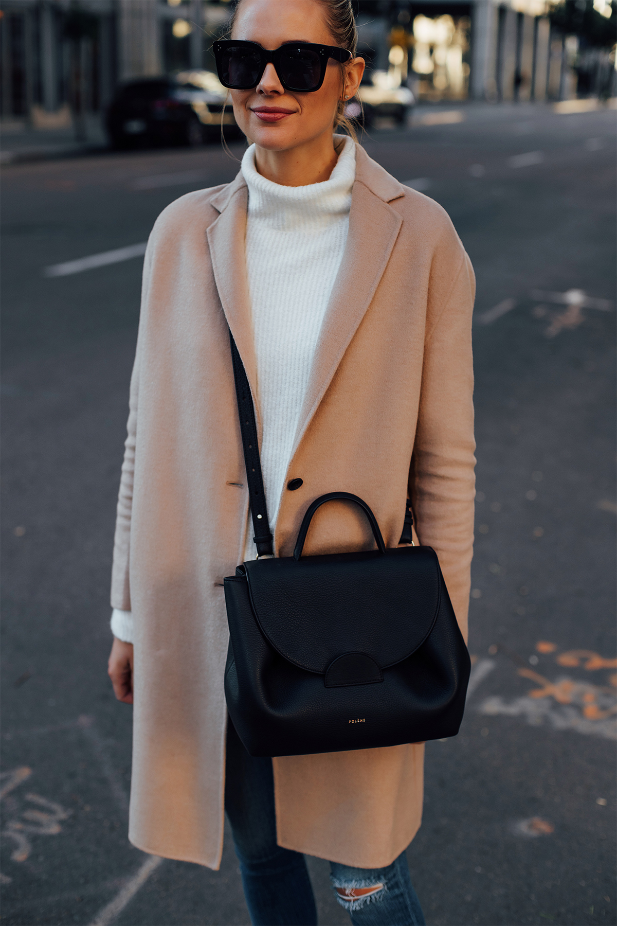 Blonde Woman Wearing AllSaints Camel Coat White Sweater Denim Skinny Ripped Jeans Polene Black Handbag Fashion Jackson San Diego Fashion Blogger Street Style