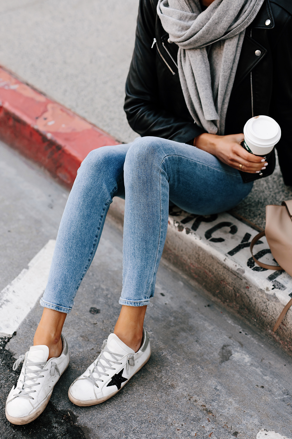 Blonde Woman Wearing Black Leather Jacket Grey Scarf Denim Skinny Jeans Golden Goose Sneakers Fashion Jackson San Diego Fashion Blogger Street Style