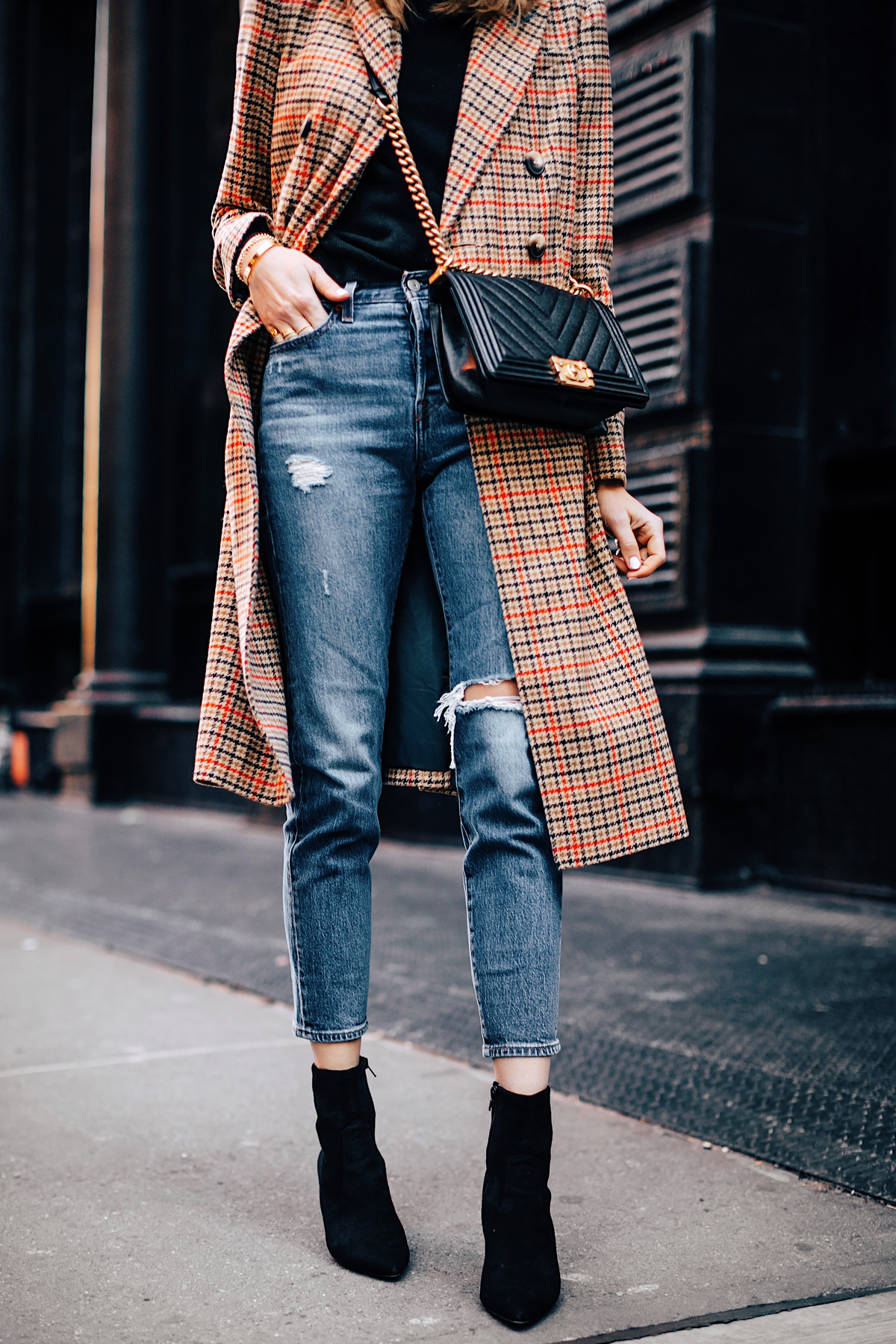 Woman Wearing Topshop Plaid Long Coat Black Sweater Levis Wedgie Fit Ripped Jeans Black Booties Chanel Boy Bag Black Fashion Jackson Fashion Blogger NYFW Street Style