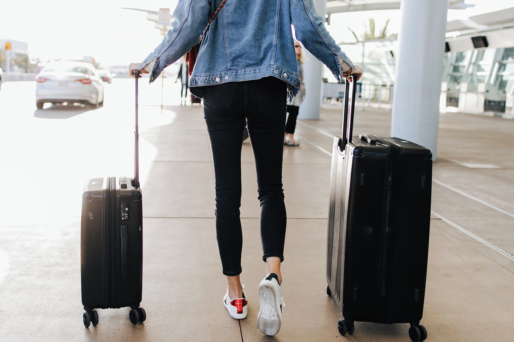 Fashion Jackson Airport Style Calpak Black Ambeur Spinner Luggage Set Wearing Denim Jacket Black Skinny Jeans Gucci Sneakers