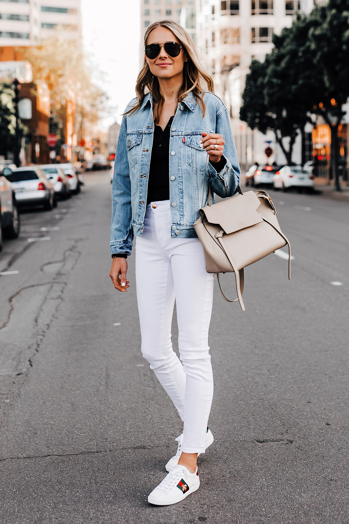 Blonde Woman Wearing Black Henley Joes Jeans White Skinny Jeans Levis Denim Jacket Gucci Ace Embroidered Sneakers Celine Mini Belt Bag Taupe Fashion Jackson San Diego Fashion Blogger Street Style