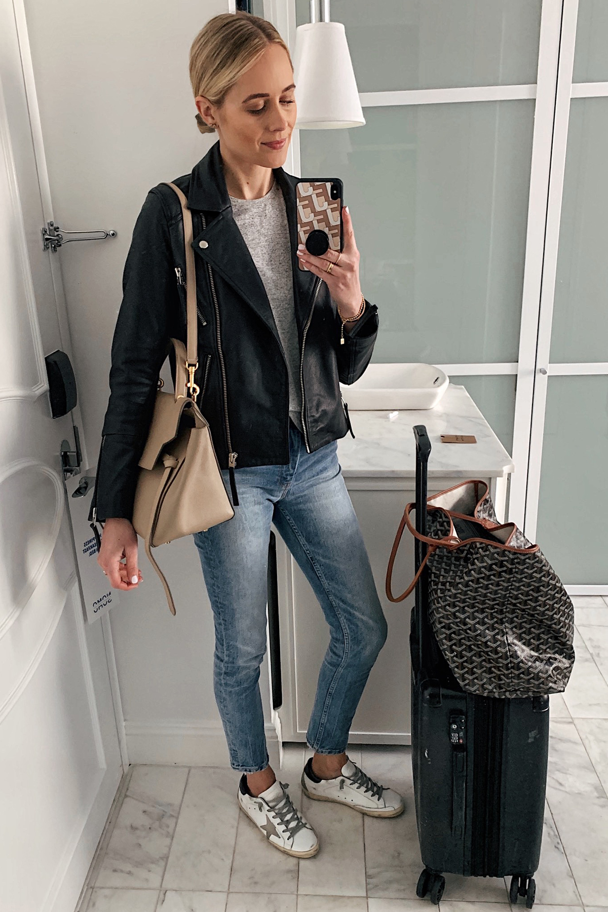 Fashion Jackson Wearing Black Leather Jacket Grey Tshirt Denim Skinny Jeans Goyard Tote Calpack Luggage Airport Outfit