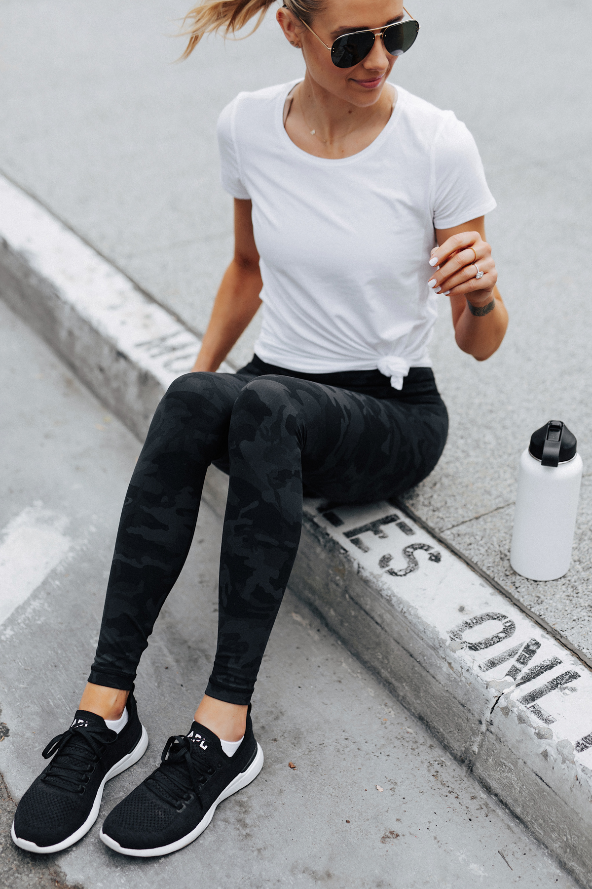 Blonde Woman Wearing Lululemon Align Pants Black Camo Print White Top APL Black Sneakers Fashion Jackson San Diego Fashion Blogger Fitness Style