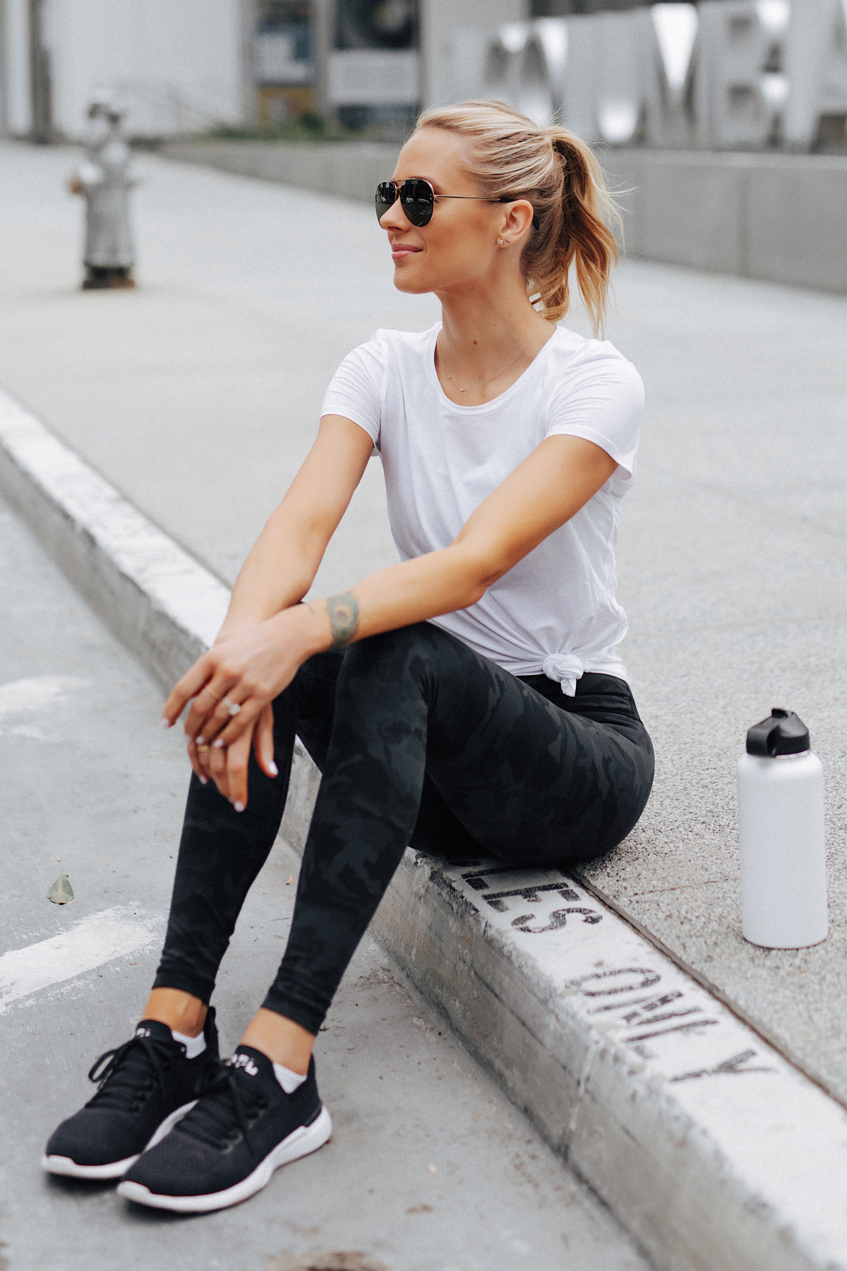 Blonde Woman Wearing Lululemon Align Pants Black Camo Print White Top APL Black Sneakers Fashion Jackson San Diego Fashion Blogger Fitness Style