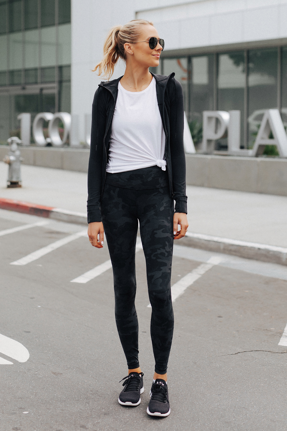 Blonde Woman Wearing Lululemon Align Pants Black Camo Print White Top Black Jacket APL Black Sneakers Fashion Jackson San Diego Fashion Blogger Fitness Style