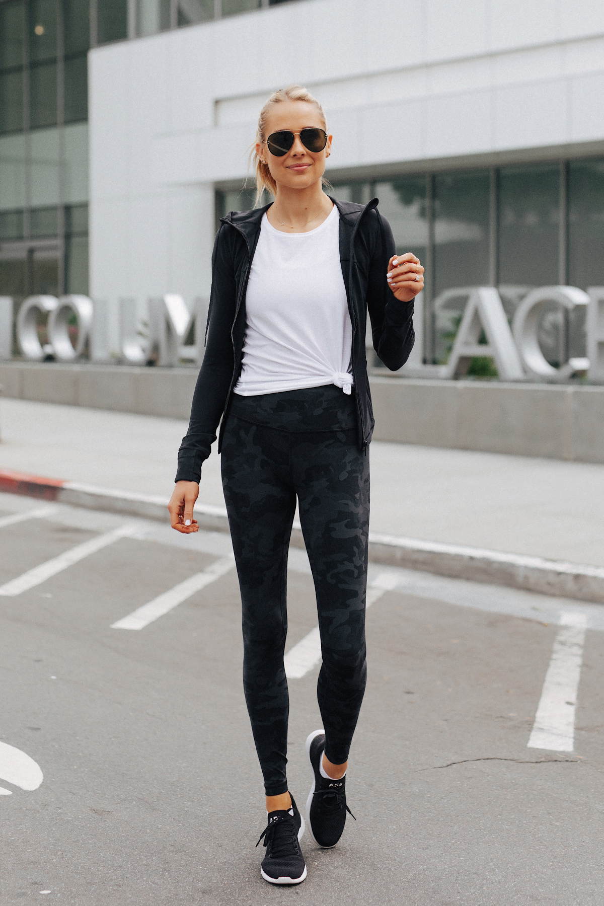 Blonde Woman Wearing Lululemon Align Pants Black Camo Print White Top Black Jacket APL Black Sneakers Fashion Jackson San Diego Fashion Blogger Fitness Style