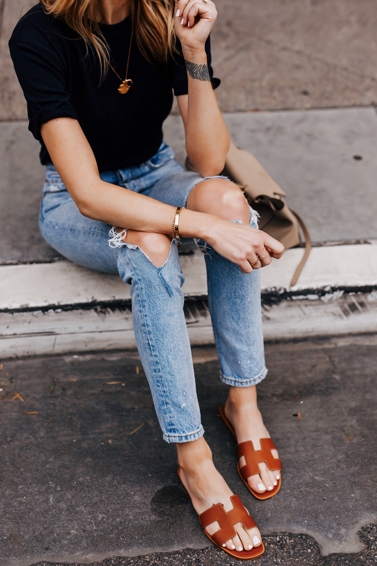 Woman Wearing Black Tshirt Ripped Jeans Hermes Oran Gold Sandals Fashion Jackson San Diego Fashion Blogger Street Style