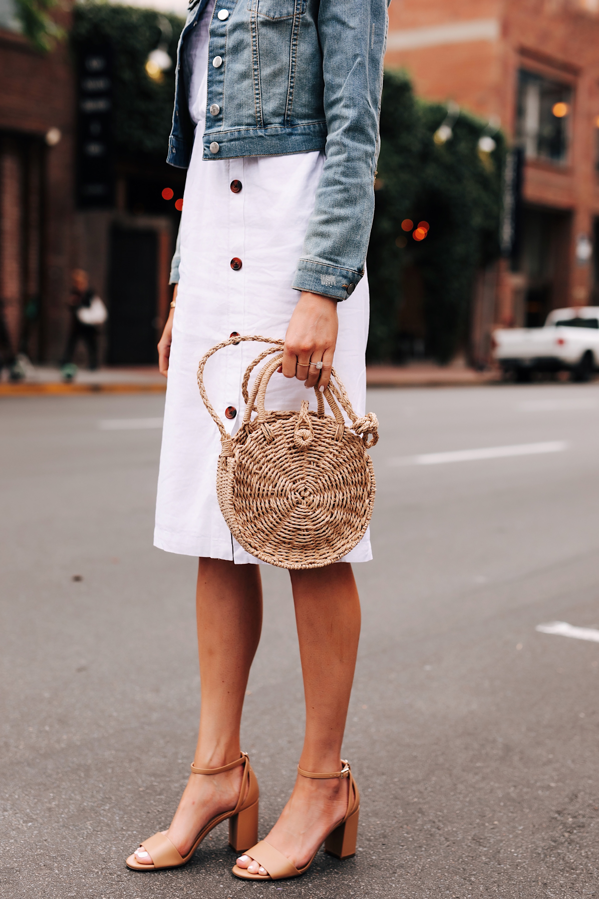 Blonde Woman Wearing Denim Jacket White Midi Dress Straw Circle Handbag Tan Ankle Strap Heeled Sandals Fashion Jackson San Diego Fashion Blogger Street Style