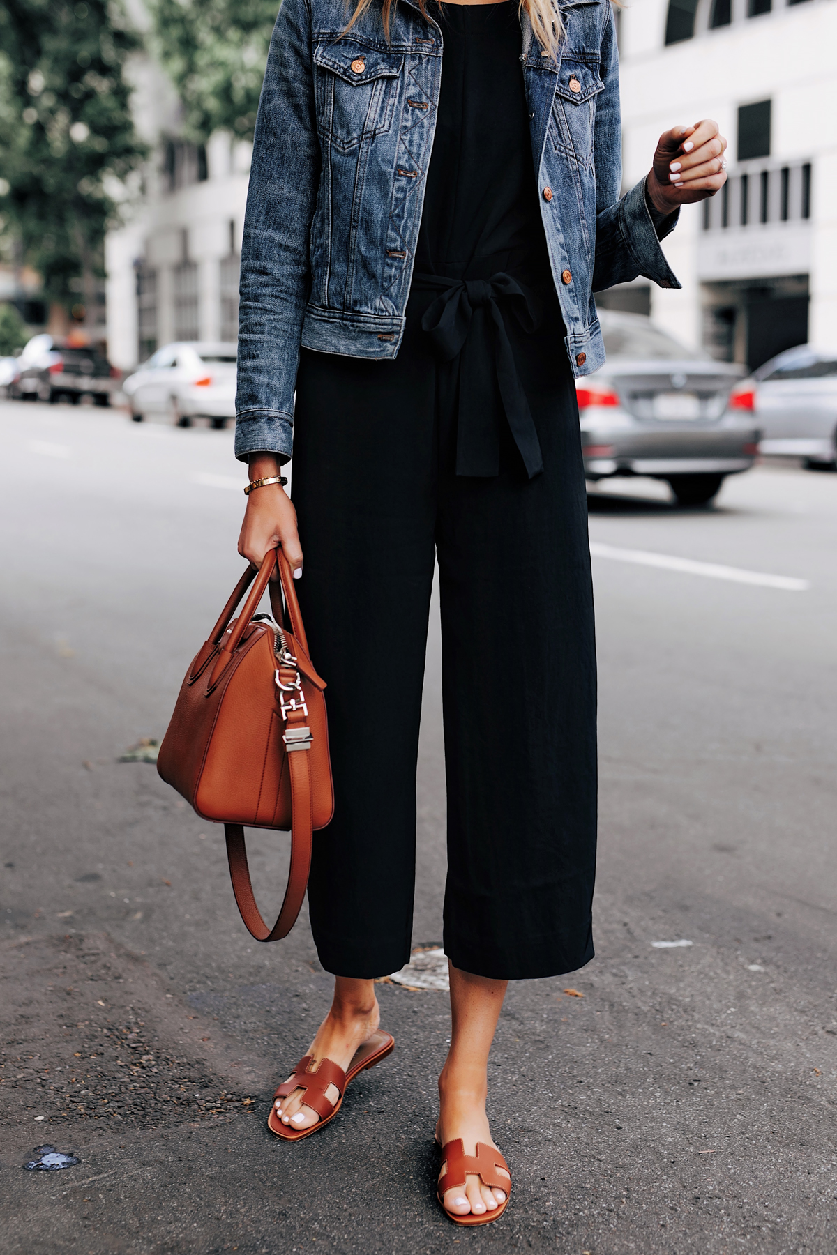 Woman Wearing Everlane Black Jumpsuit Denim Jacket Tan Sandals Tan Tote Fashion Jackson San Diego Fashion Blogger Street Style