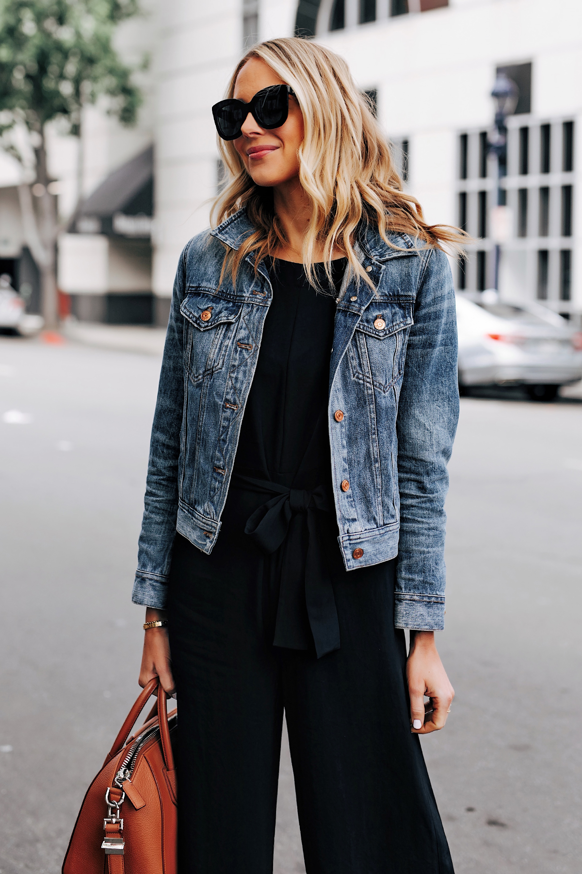 black jumpsuit and denim jacket