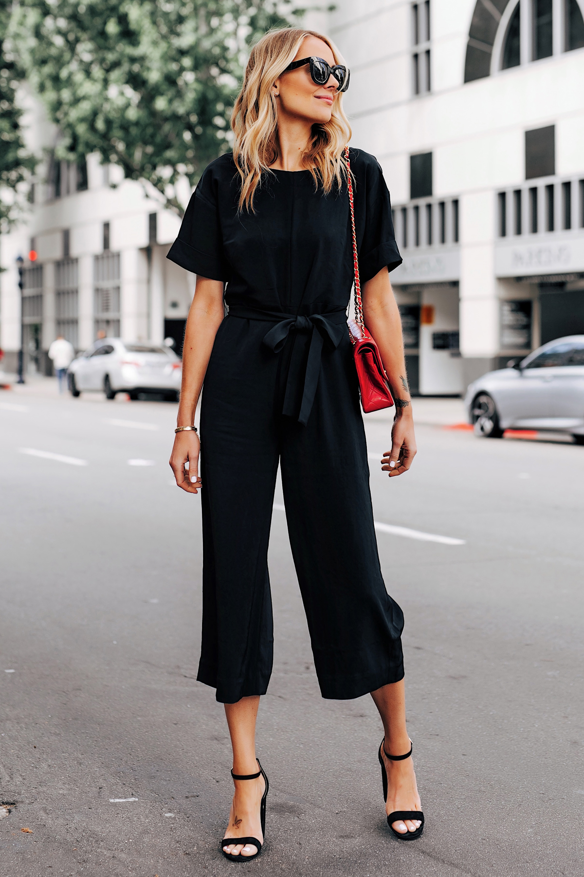 Blonde Woman Wearing Everlane Black Tie Waist Jumpsuit Chanel Red Handbag Black Heeled Sandals Fashion Jackson San Diego Fashion Blogger Street Style