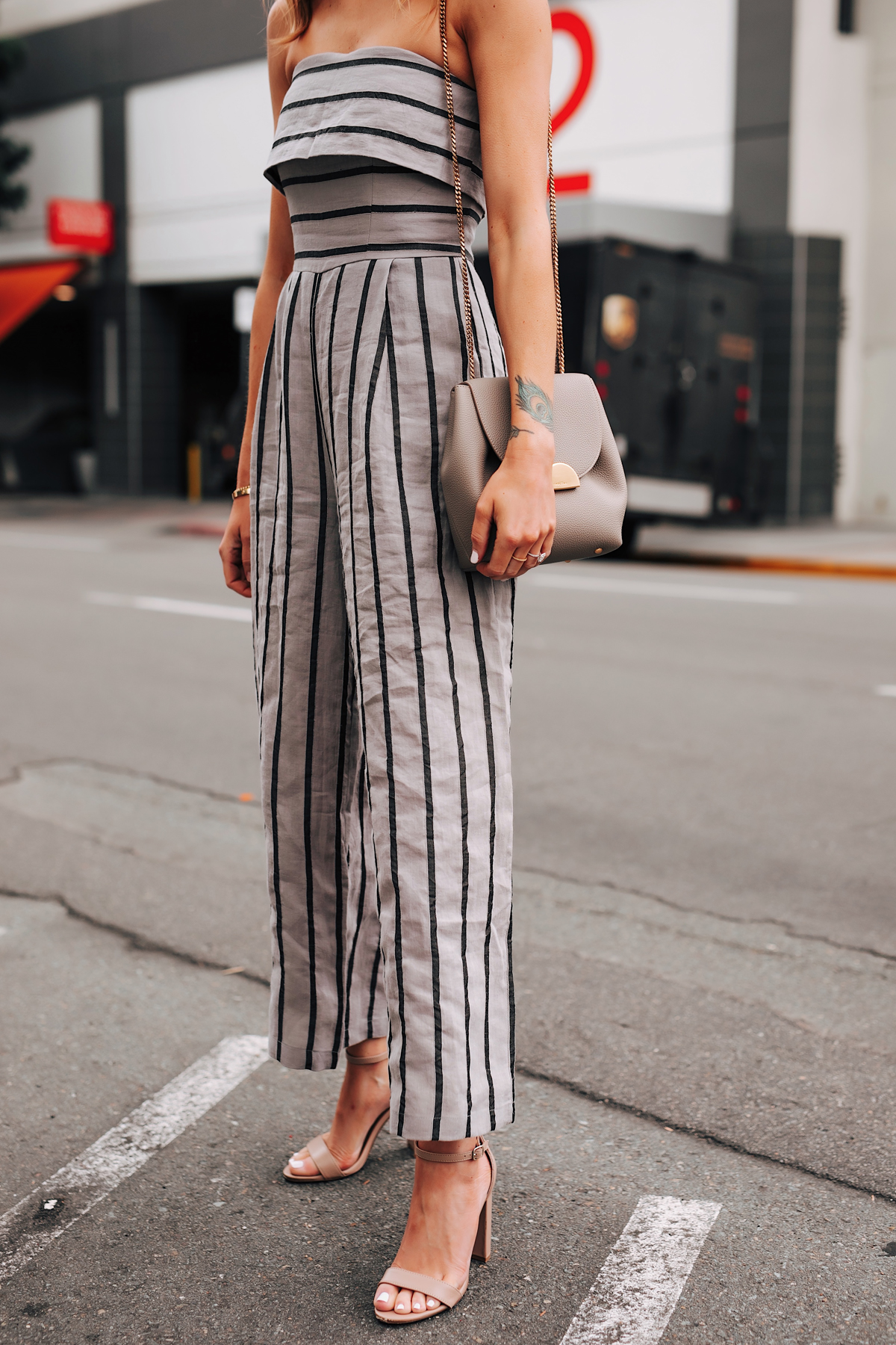 Woman Wearing Grey Strapless Stripe Jumpsuit Heeled Sandals Fashion Jackson San Diego Fashion Blogger Street Style