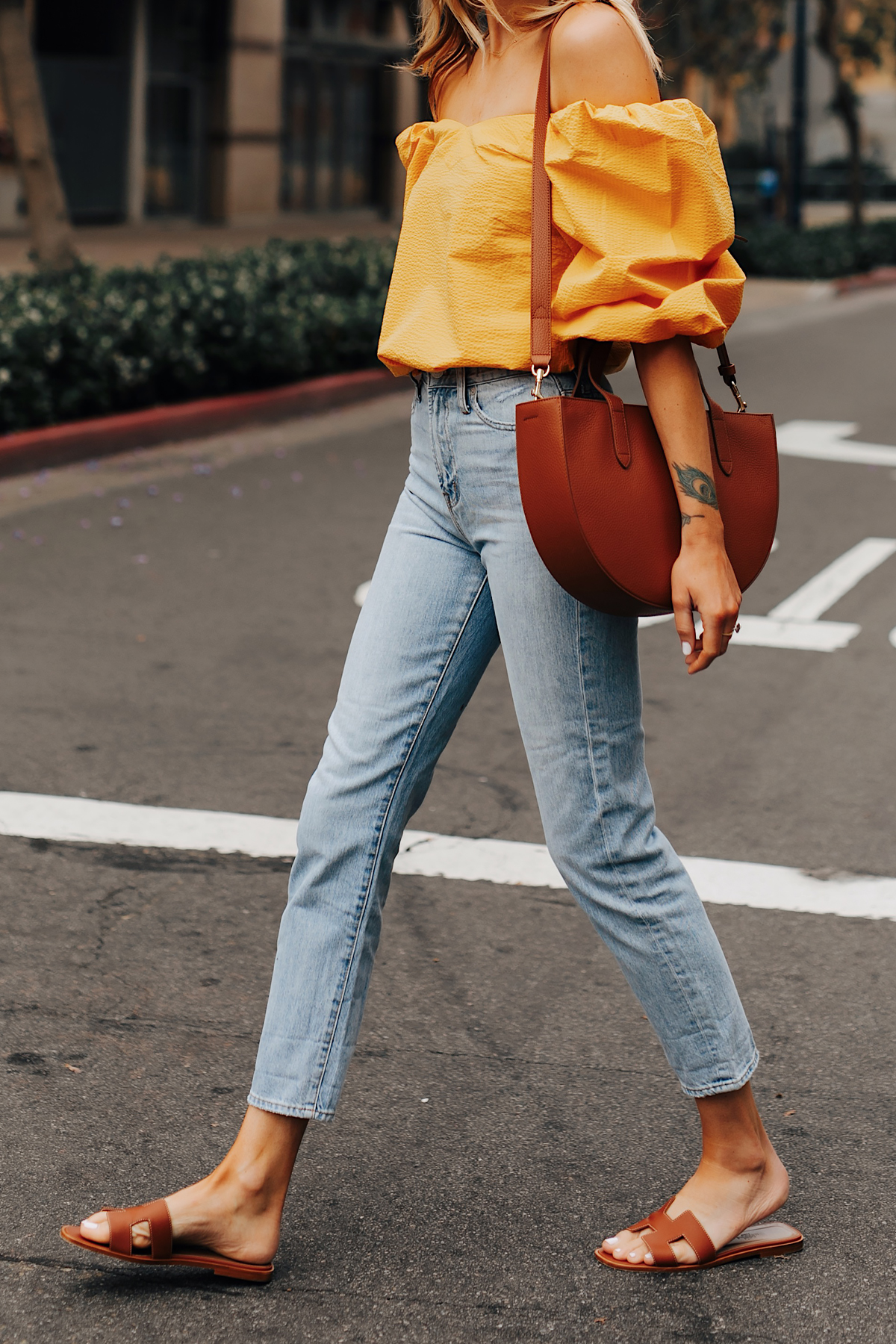 Fashion Jackson Wearing Cuyana Yellow Blouse Denim Ankle Jeans Hermes Oran Gold Sandals Cuyana Tan Handbag 1