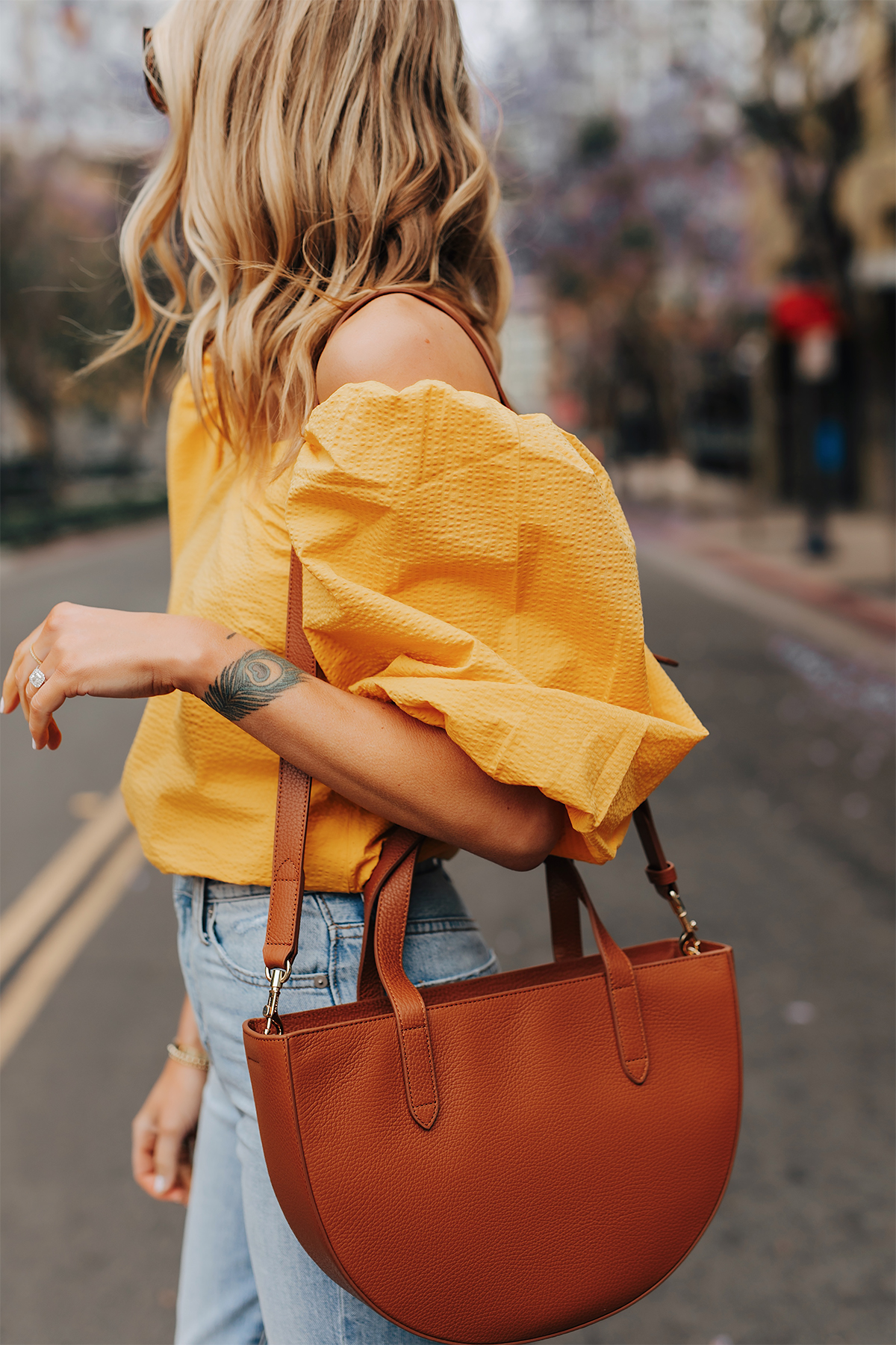 Fashion Jackson Wearing Cuyana Yellow Off the Shoulder Blouse Jeans Cuyana Tan Semi Circle Handbag